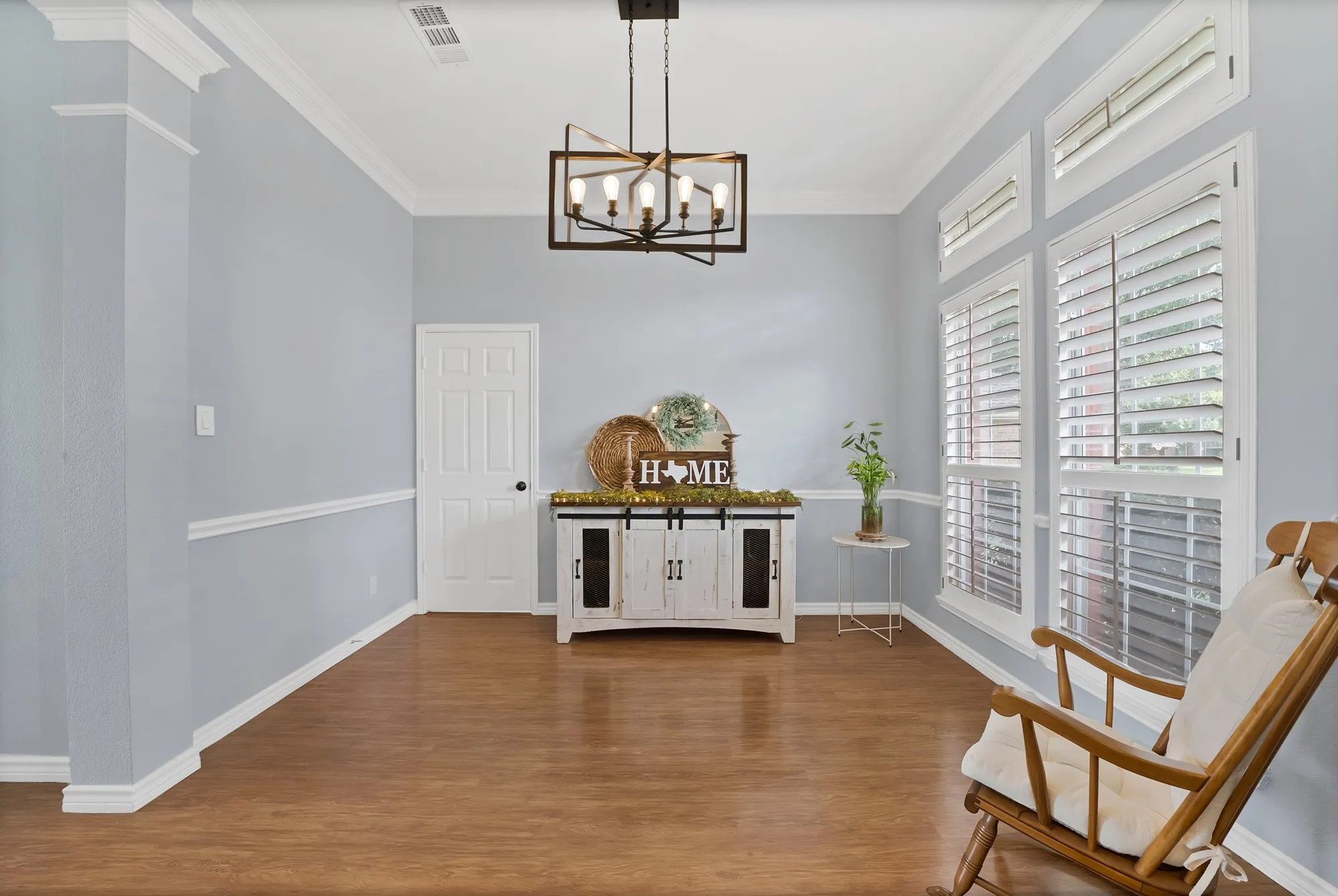Wood-finish flooring, crown molding, and plantation shutters