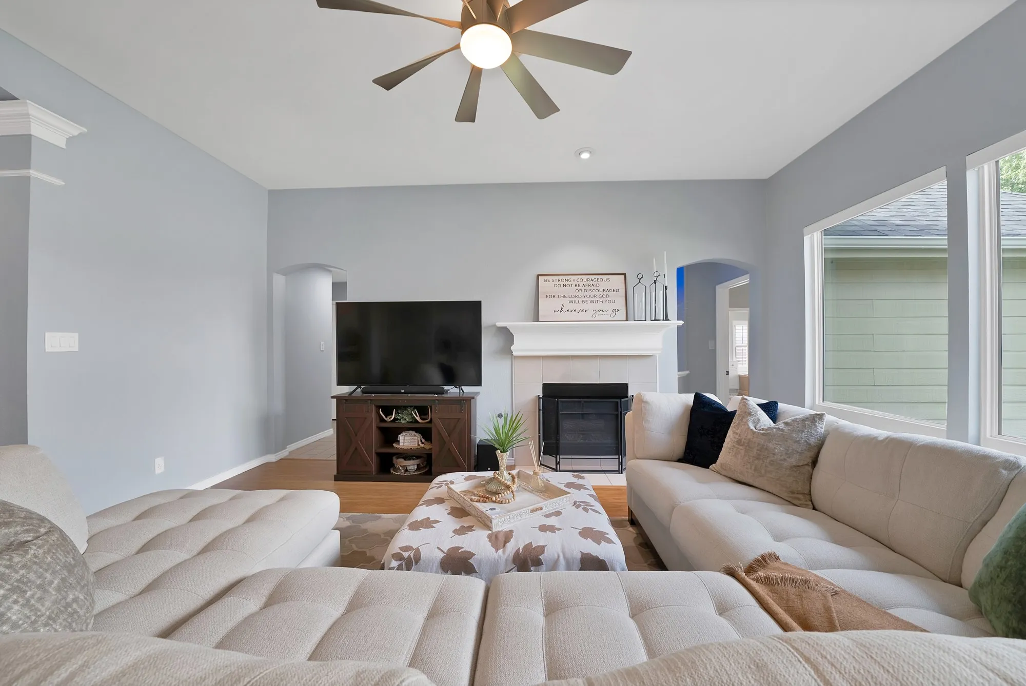 Hardwood-finish flooring, recessed lighting, and a ceiling fan with integrated light