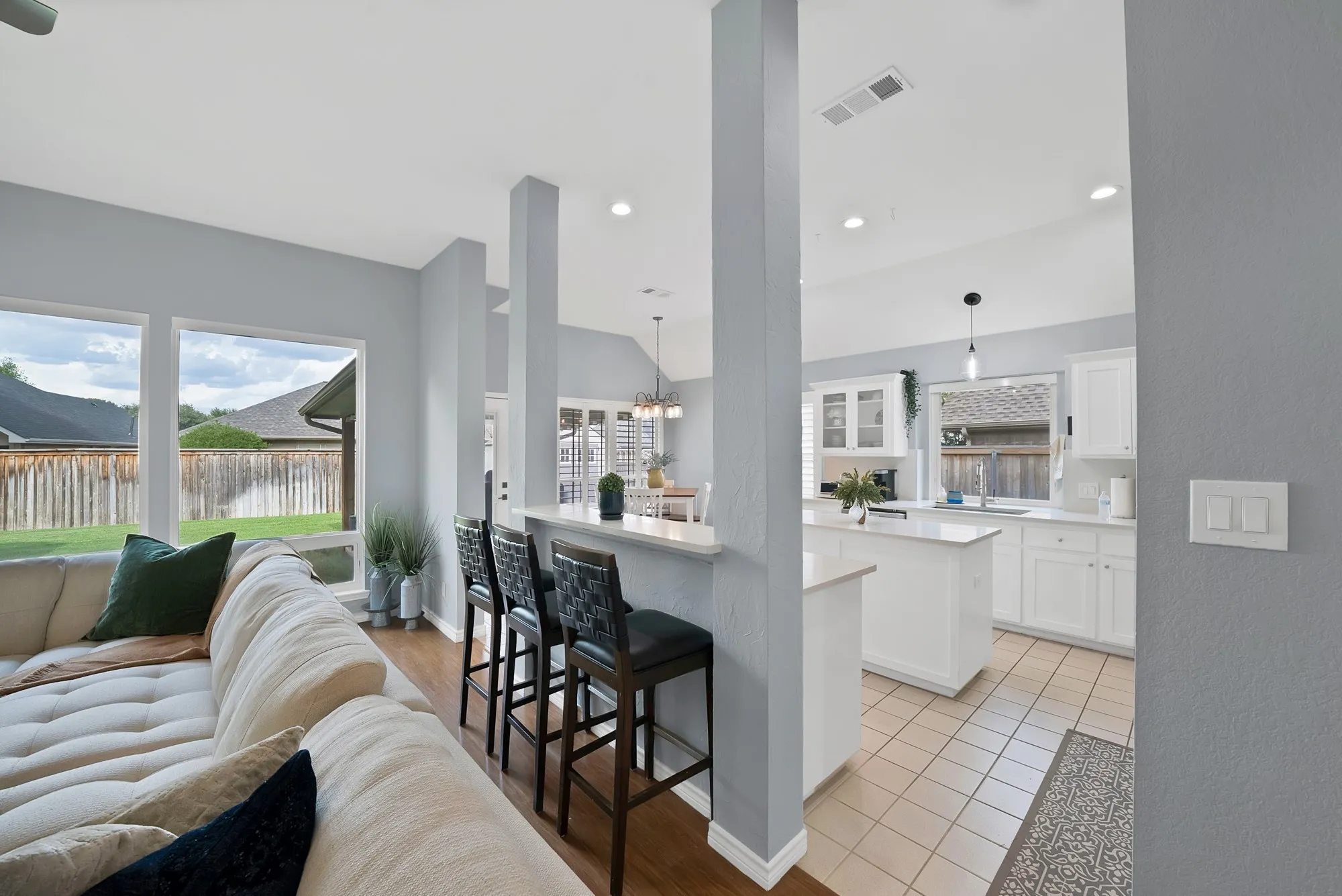 Kitchen with white cabinetry, a center island, and tile flooring
