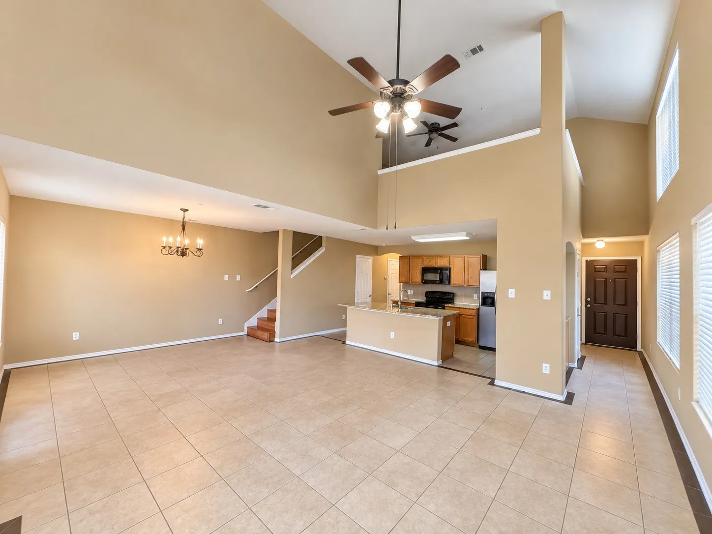 Vaulted ceilings, open concept floor plan, and ceramic tile flooring throughout