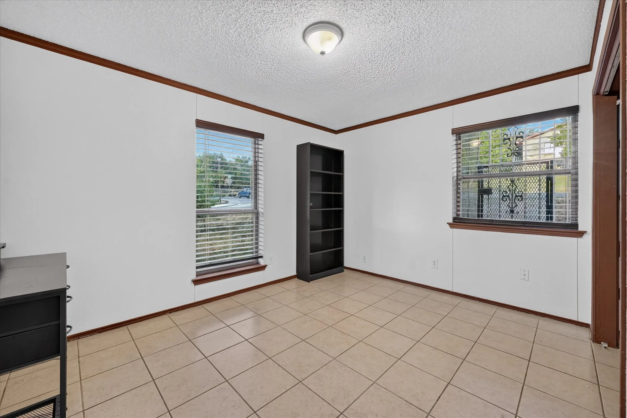 Tile flooring with white walls and dark wood trim