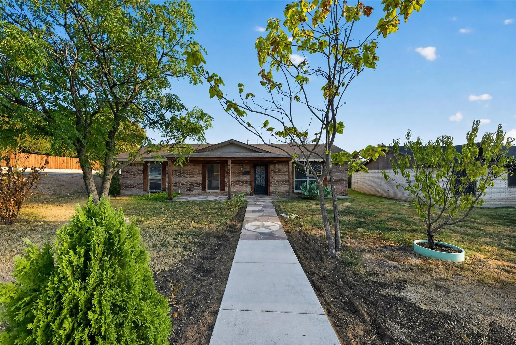 Brick exterior with a covered front porch and a paved walkway