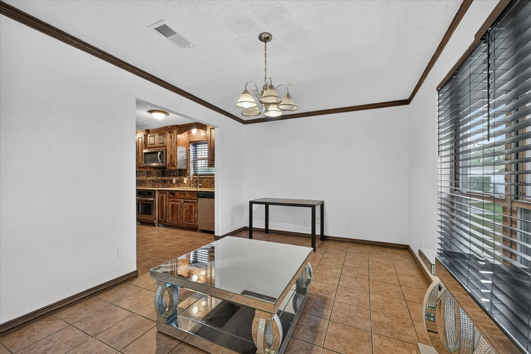 Tiled flooring and crown molding in a bright interior space