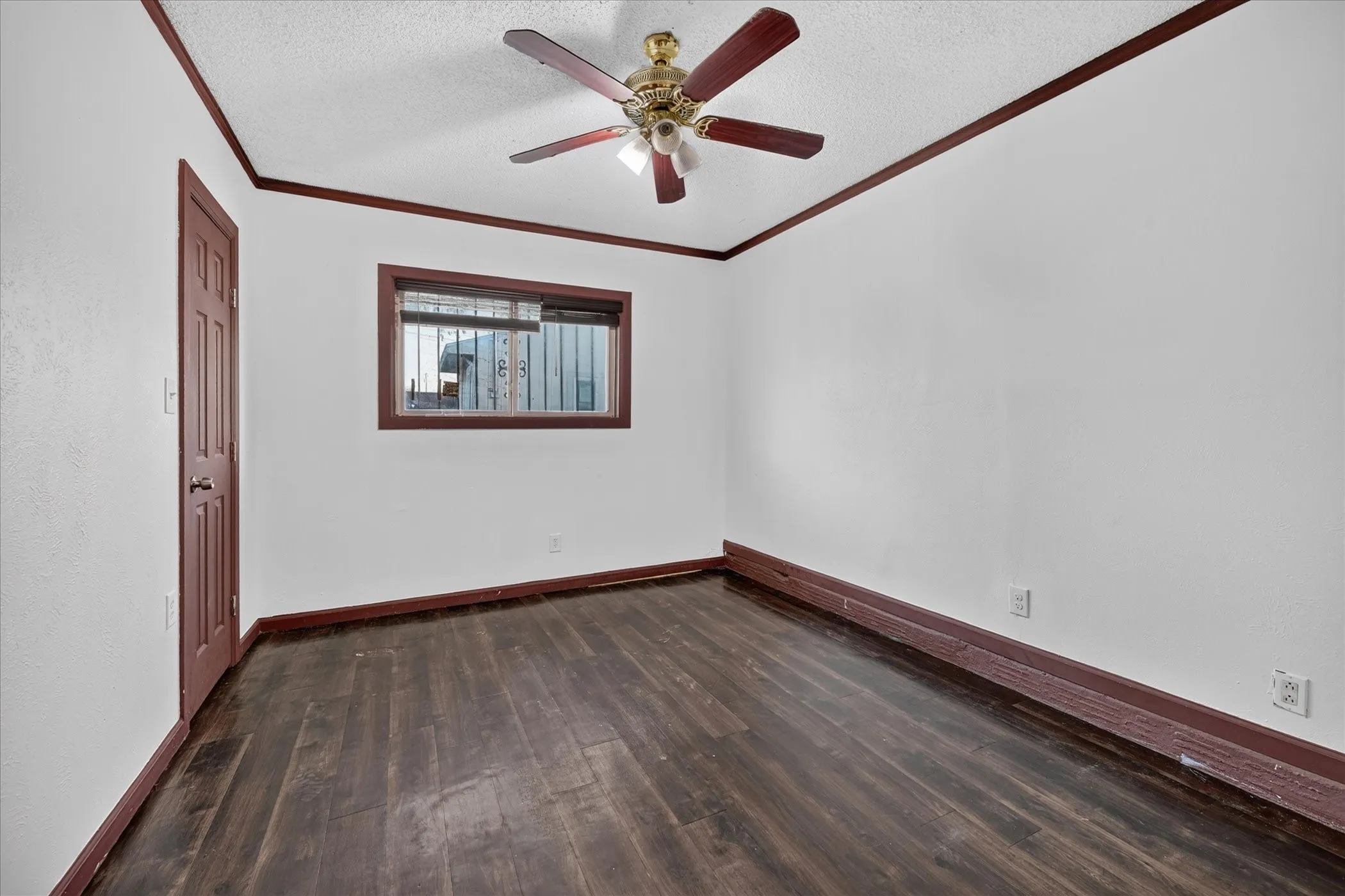 Wood-finish flooring, white walls, and dark wood trim