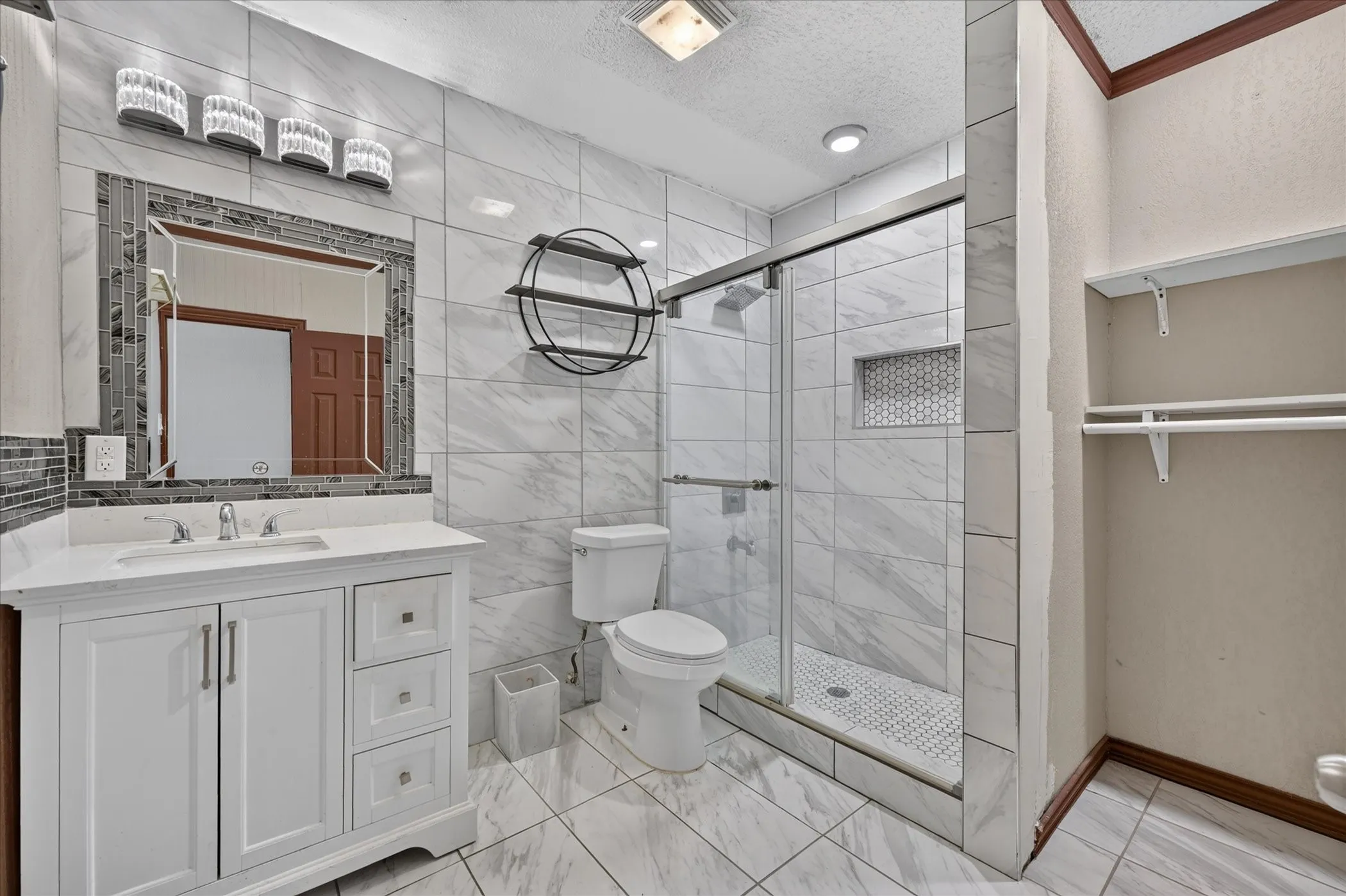 White vanity with an integrated sink and chrome fixtures