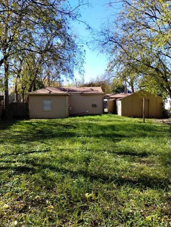 Expansive grassy yard with mature trees