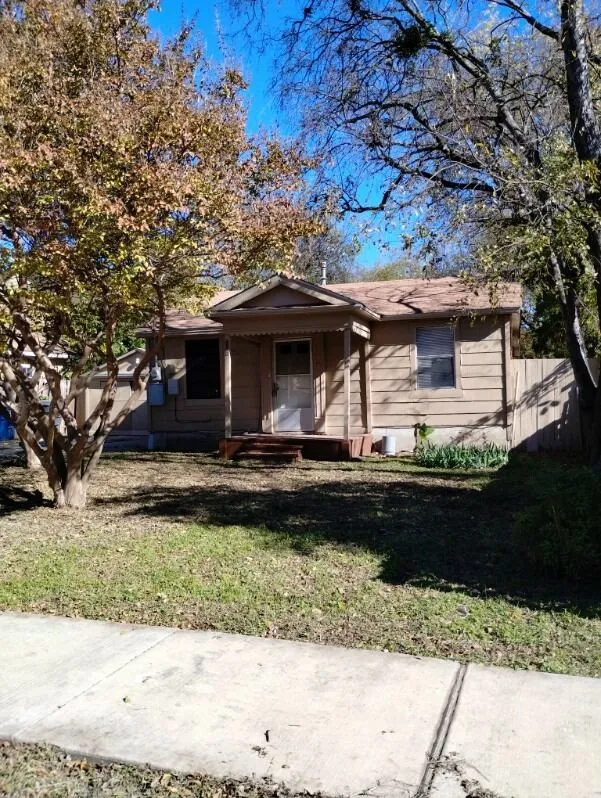 Single-story residence featuring horizontal siding, a covered front porch, and a fenced side yard
