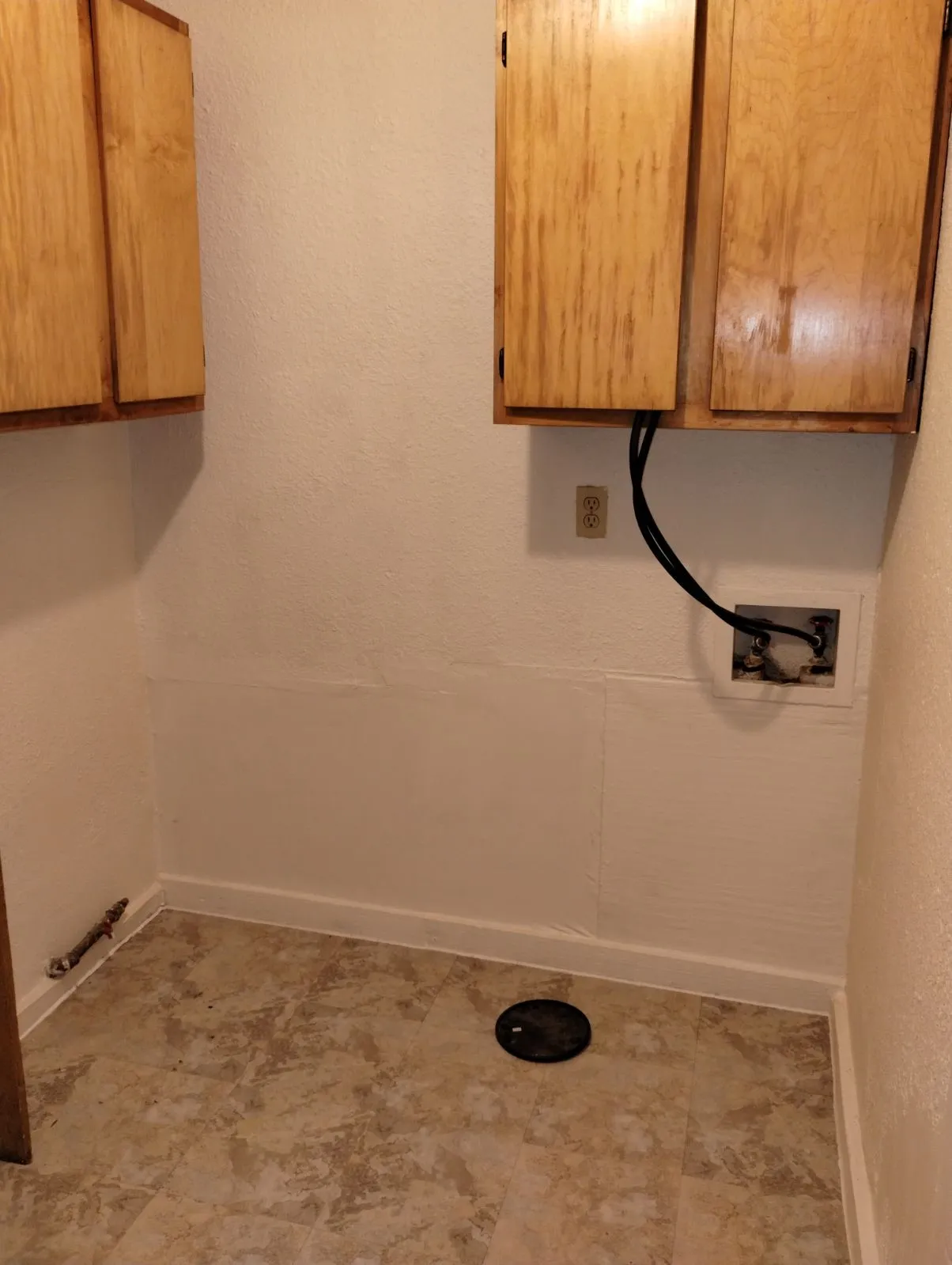 Wood-finish wall cabinets, durable vinyl flooring, and utility hookups
