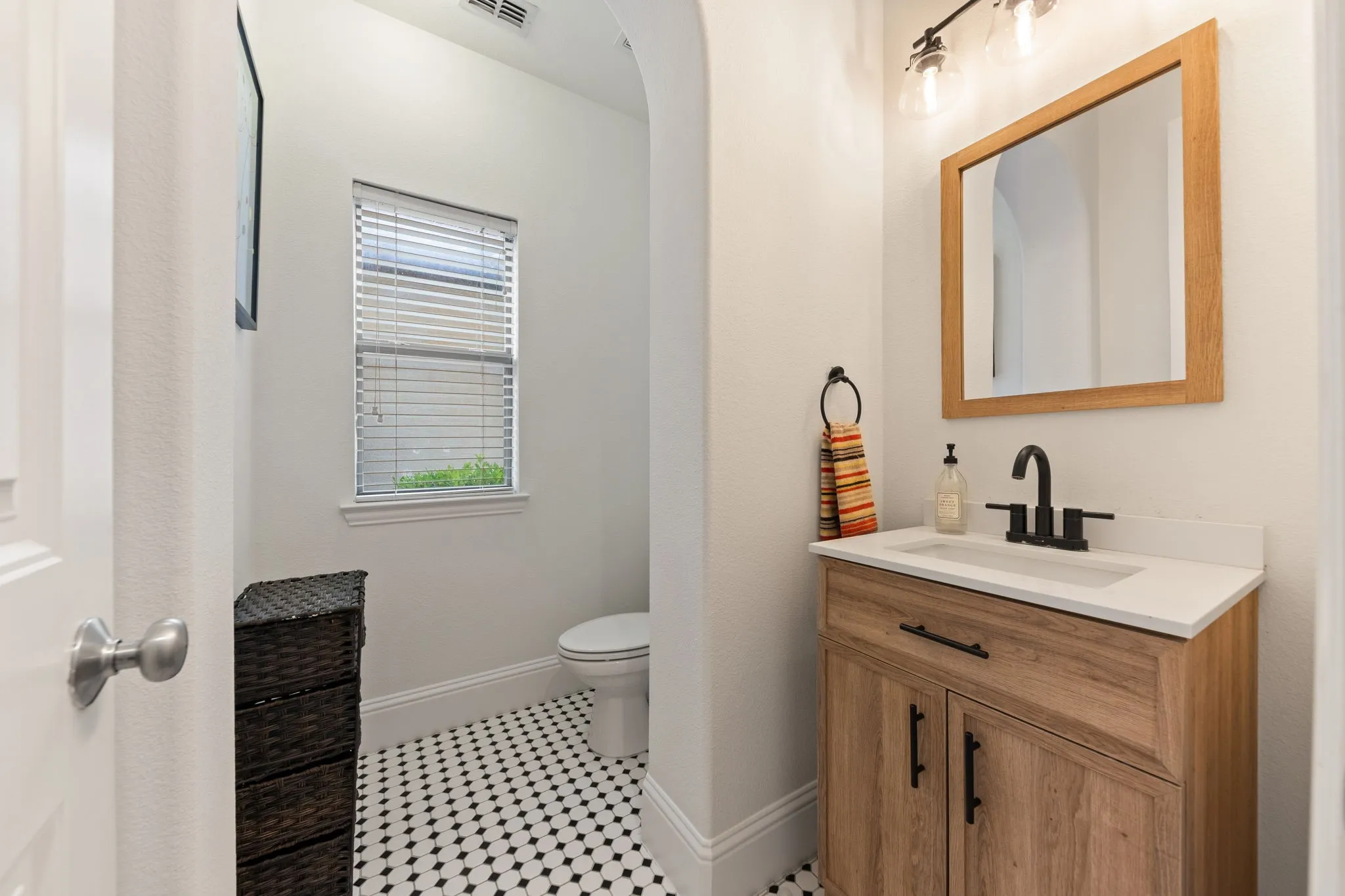Wood-finish vanity with a white countertop and rectangular sink