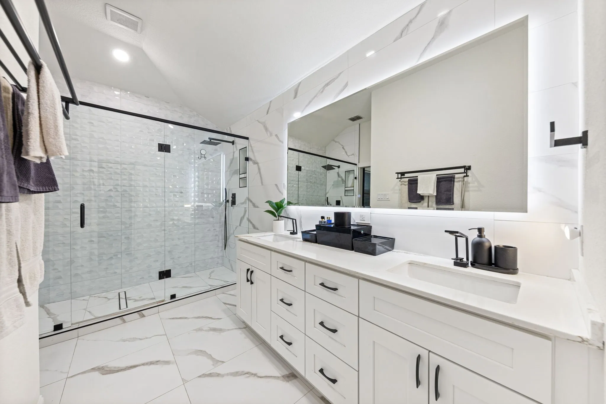 Dual sink vanity with white cabinetry and quartz countertops