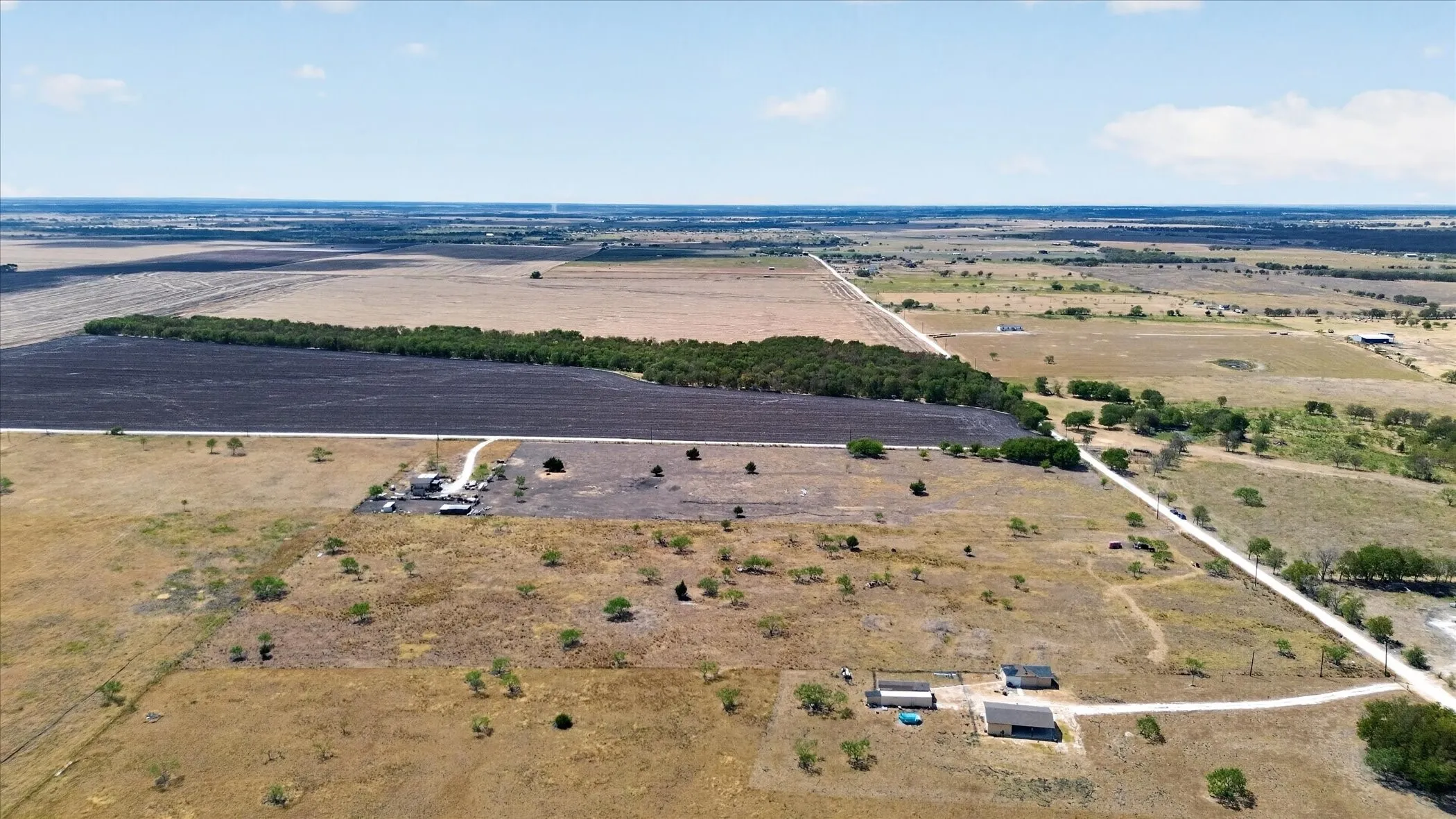 Expansive rural landscape with cultivated fields and natural vegetation