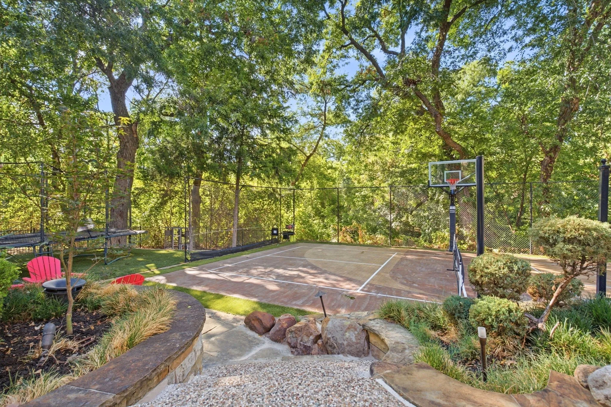 A distinctive amenity that sets this property apart is the private sports court, offering an exceptional space for recreation, competition, and family fun. Designed for versatility, the court is ideal for basketball, pickleball, tennis, volleyball, badminton, and more