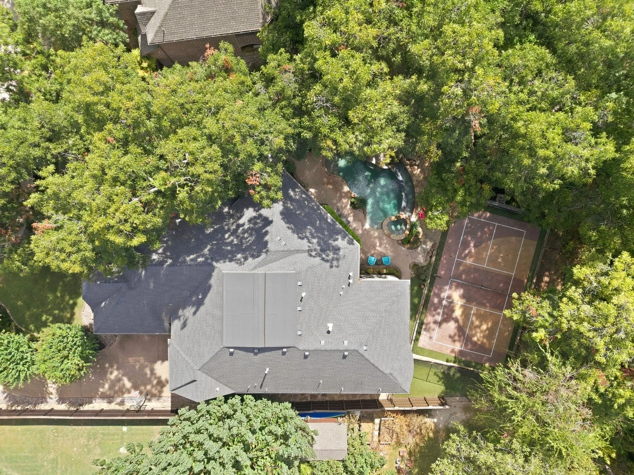 The property line extends into the wooded area and creek, allowing you to enjoy the views and sounds of nature. The creek is active when it rains and there is dual access to the creek through the metal gates.