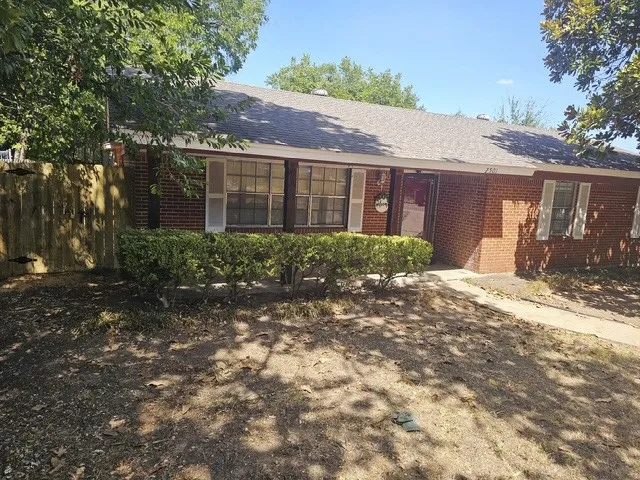 Brick exterior with white window shutters