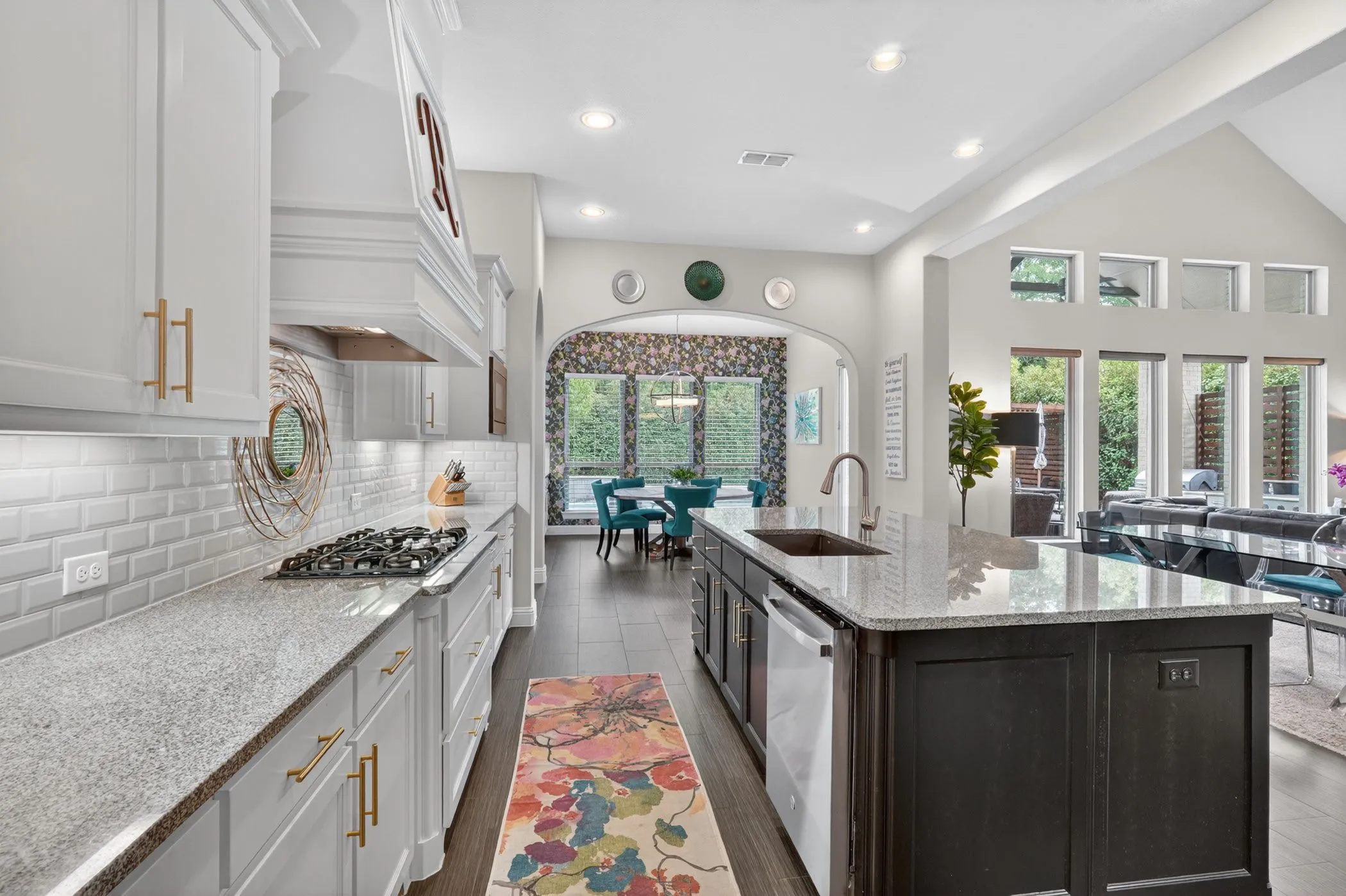Modern kitchen featuring white cabinetry, a gas cooktop, and light-toned countertops