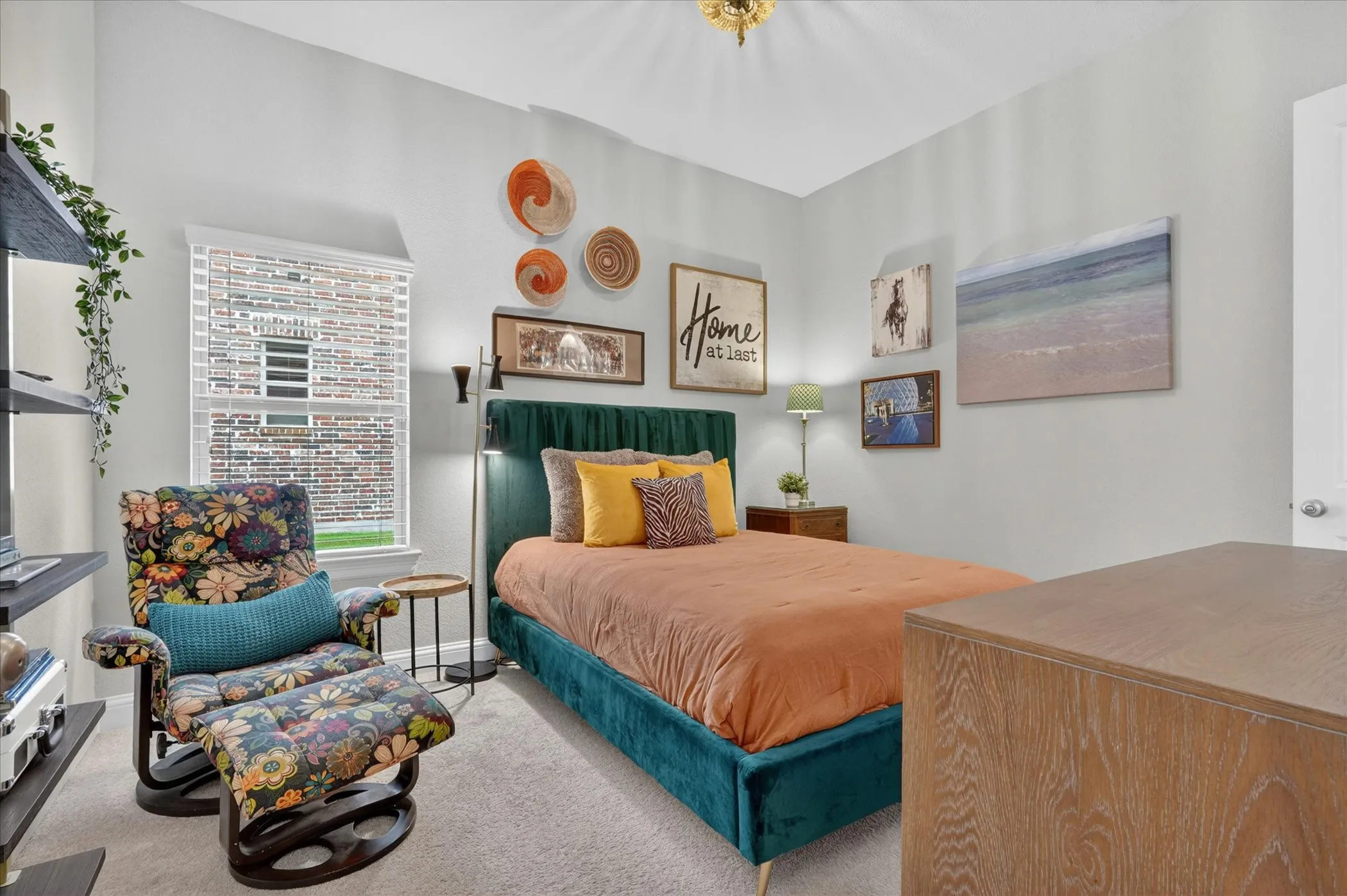 Spacious room featuring a large window with blinds, light-colored walls, and carpeting