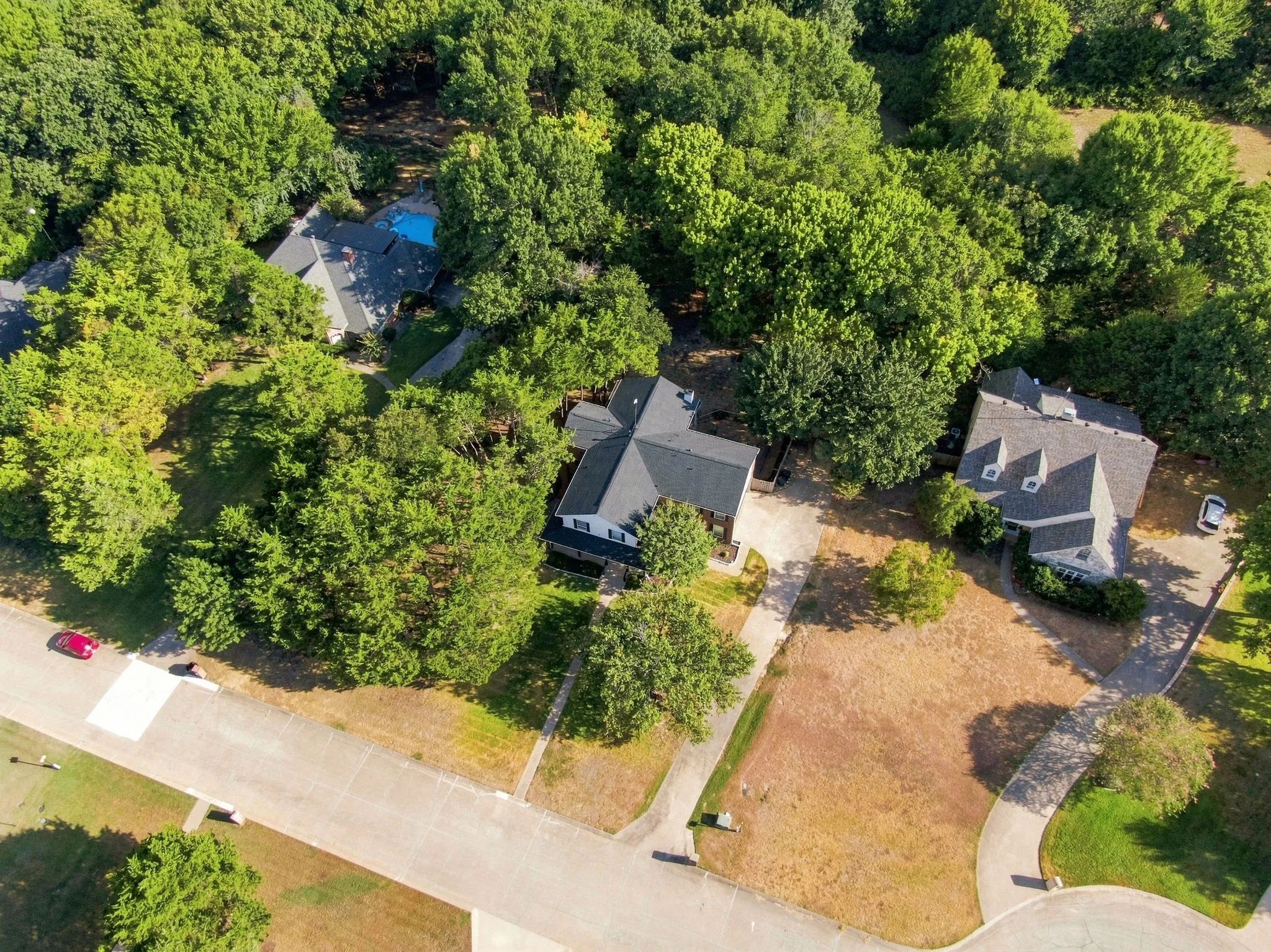 Bird's-eye view of the home tucked among beautiful towering trees