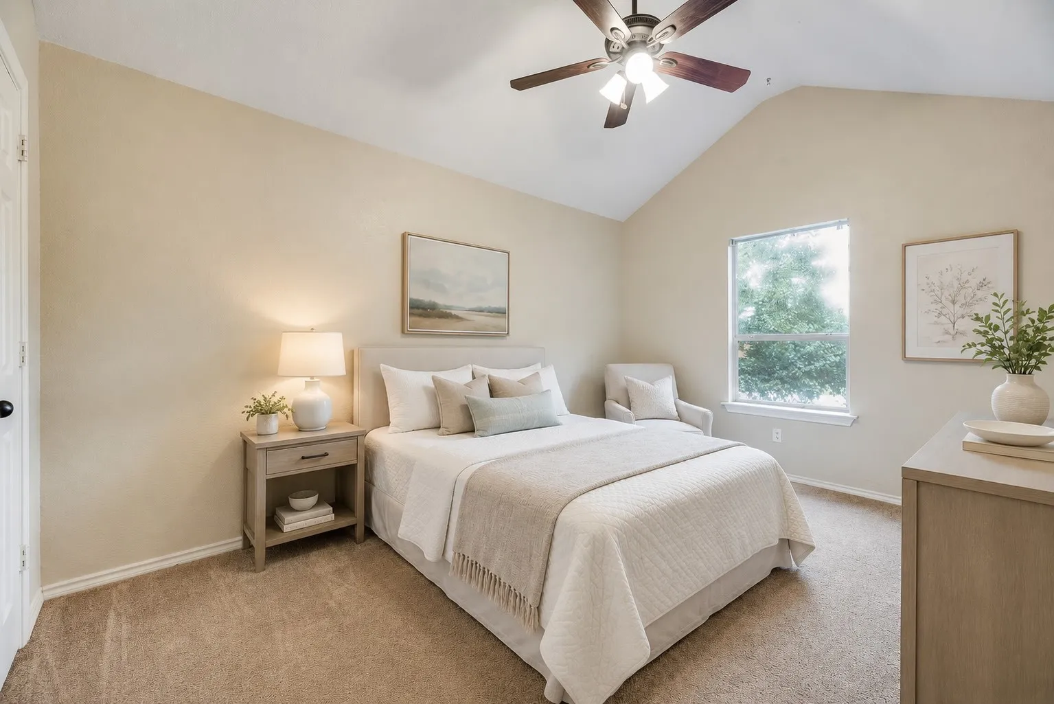 Spacious bedroom with vaulted ceilings, abundant natural light, and a comfortable layout offering plenty of room to relax and unwind.