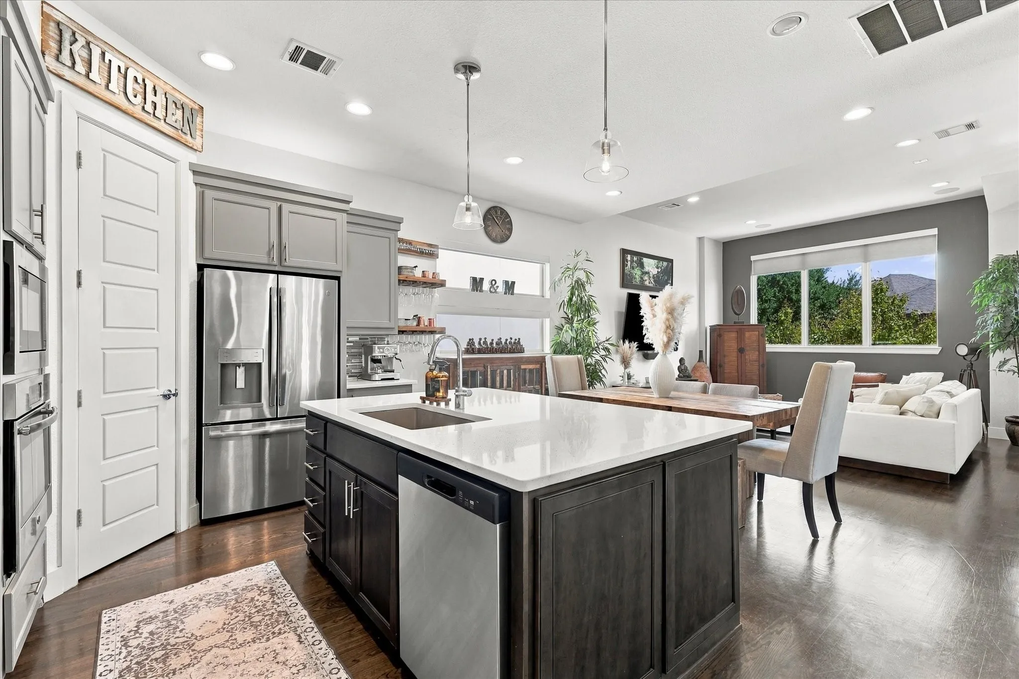 Stainless steel appliances flank the walk-in pantry with coffee bar and wine fridge off to the side.