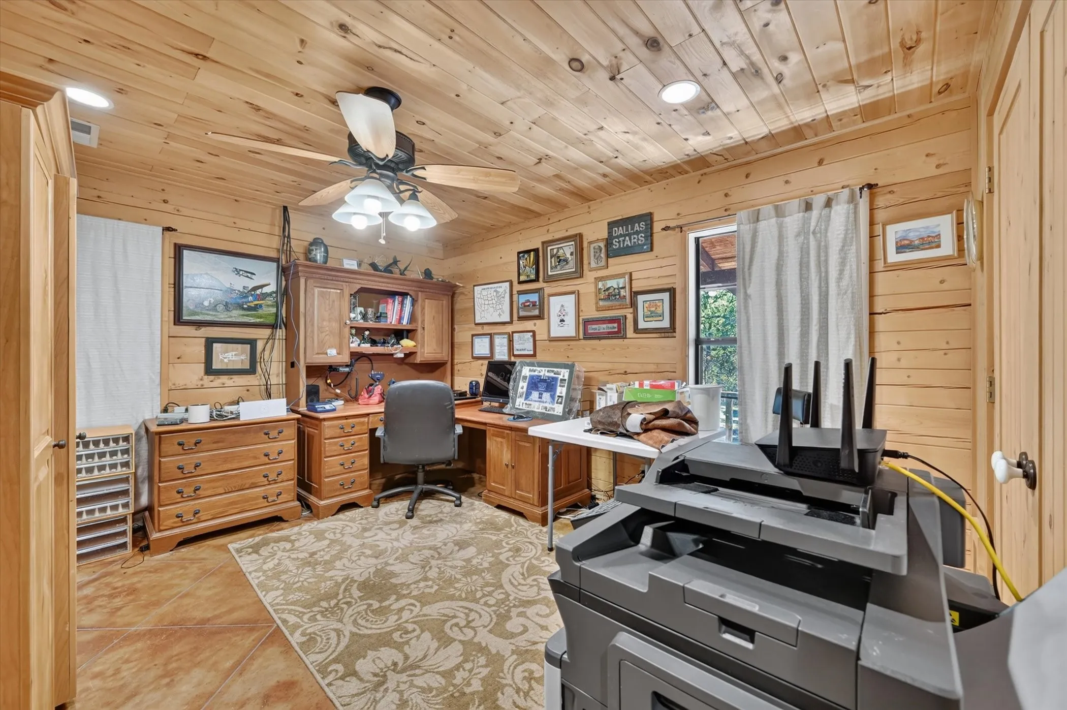 Wood-paneled walls and ceiling featuring recessed lighting