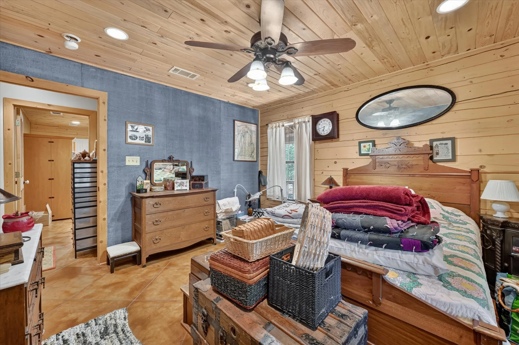 Wood-paneled ceiling with recessed lighting and ceiling fan