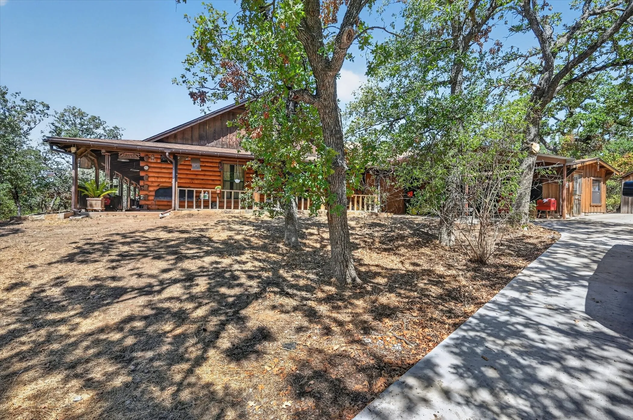 Wood-sided exterior featuring an expansive covered porch with wood columns and railings