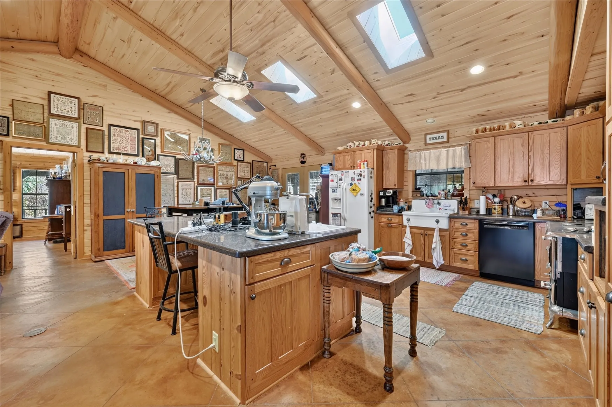 Vaulted wood-paneled ceiling with exposed beams and skylights