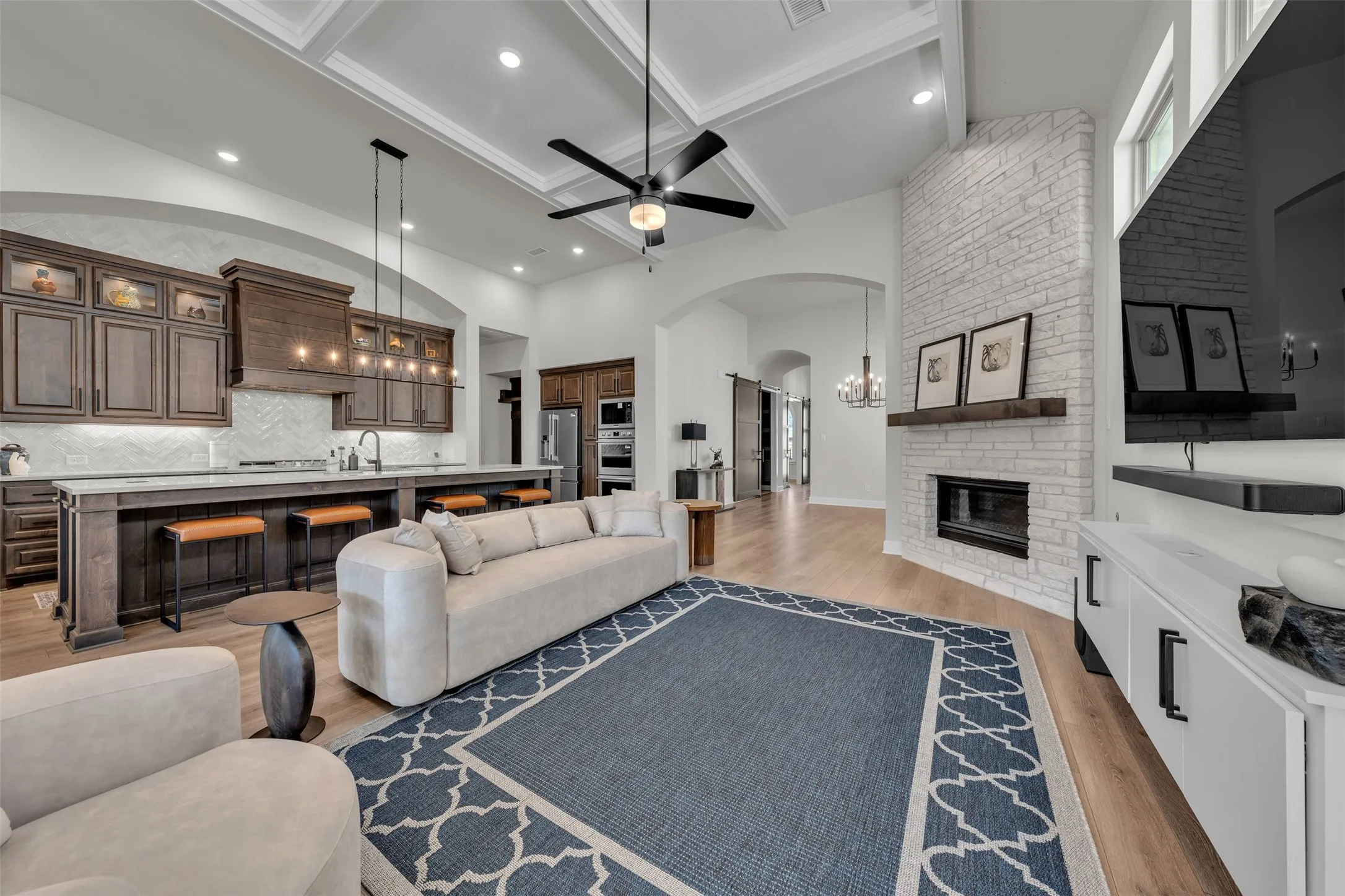 Open Concept. Coffered ceiling. Stone gas fireplace. Built in cabihnetry.