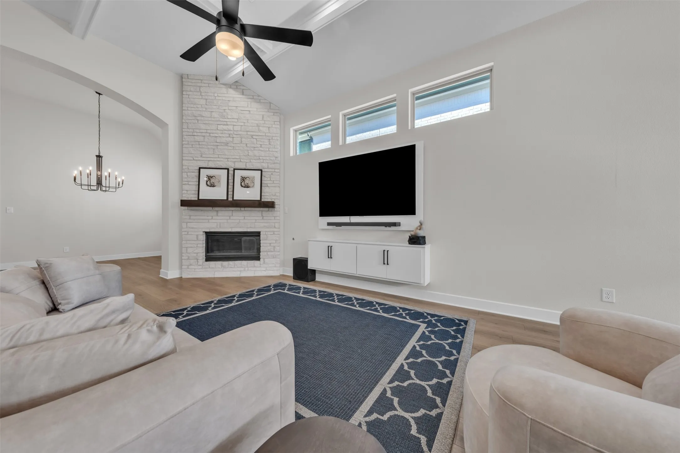 Beautiful floors anchor the spaces. Ceiling fans and cabinetry