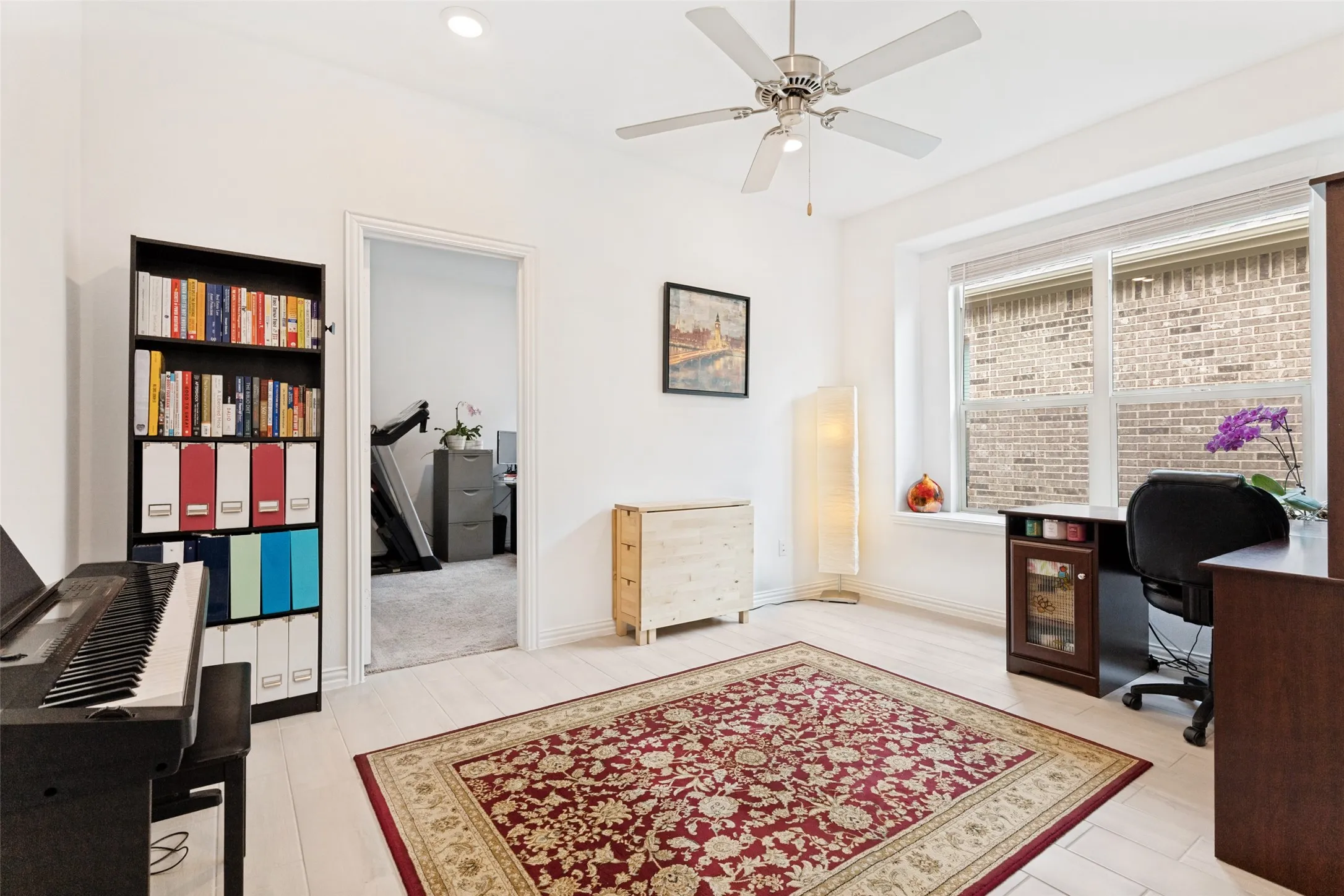 Wood-finish flooring, recessed lighting, and a ceiling fan
