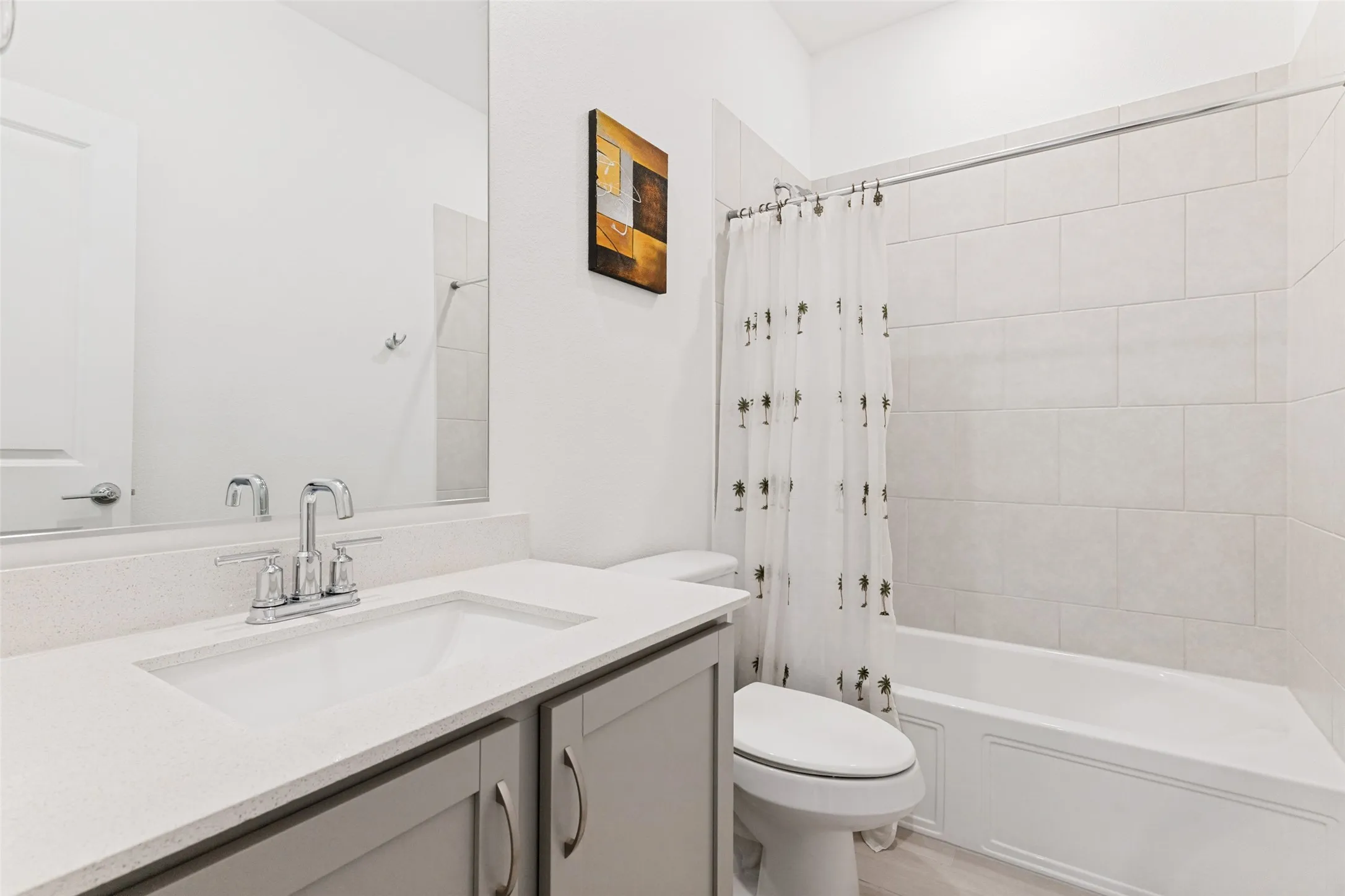 Bathroom featuring a vanity with an integrated sink, polished chrome faucet, stone-finish countertop, and built-in cabinetry