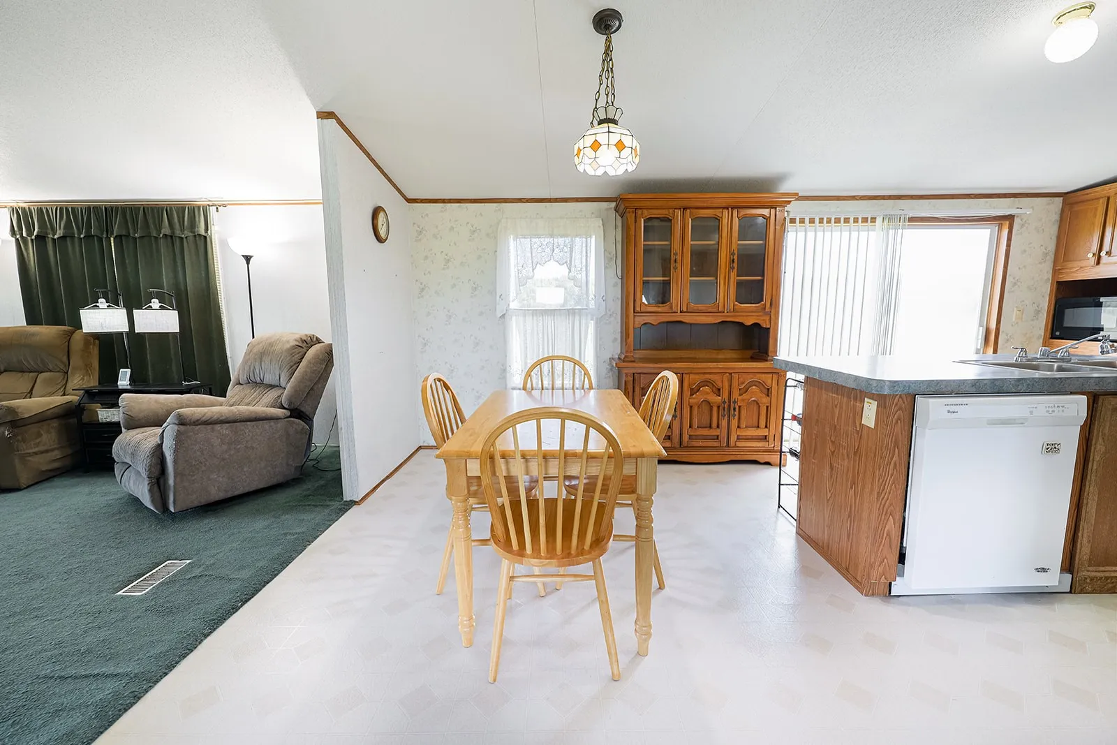 Dining area featuring vinyl flooring and wood-finish cabinetry