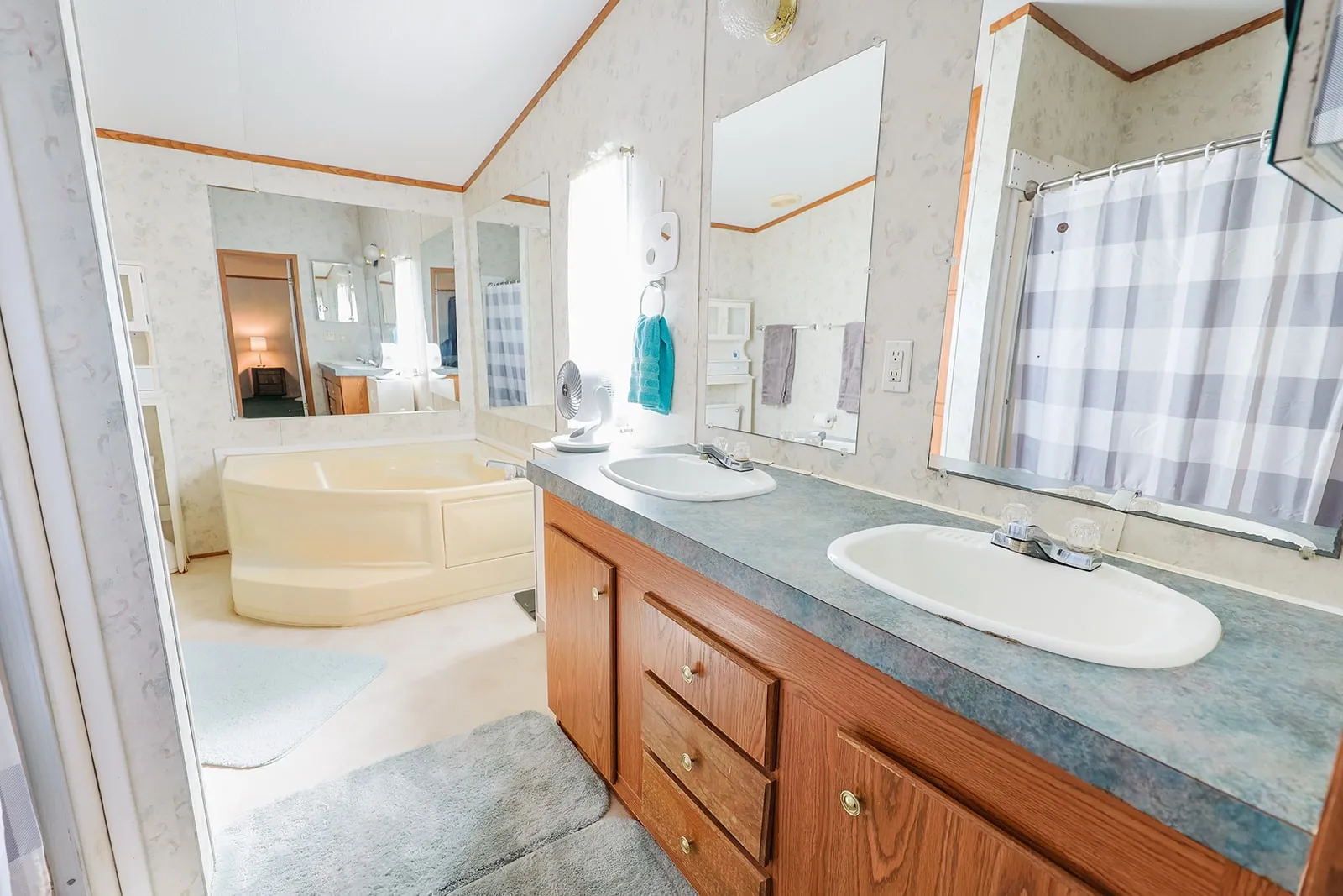 Dual vanity with integrated sinks and wood-finish cabinetry