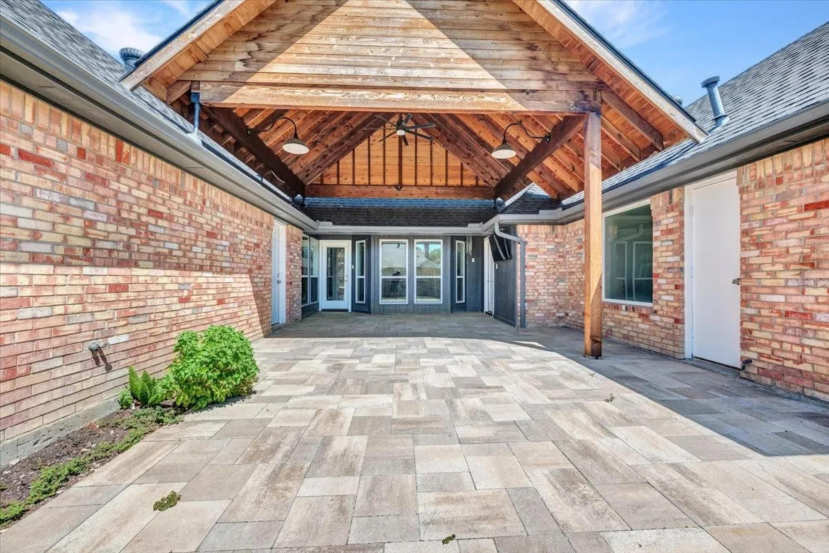 Expansive brick paver patio creates the perfect outdoor entertainment space