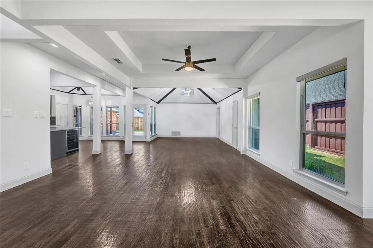 Expansive open-concept living space with two living areas and dining room opening up to the eat-in kitchen
