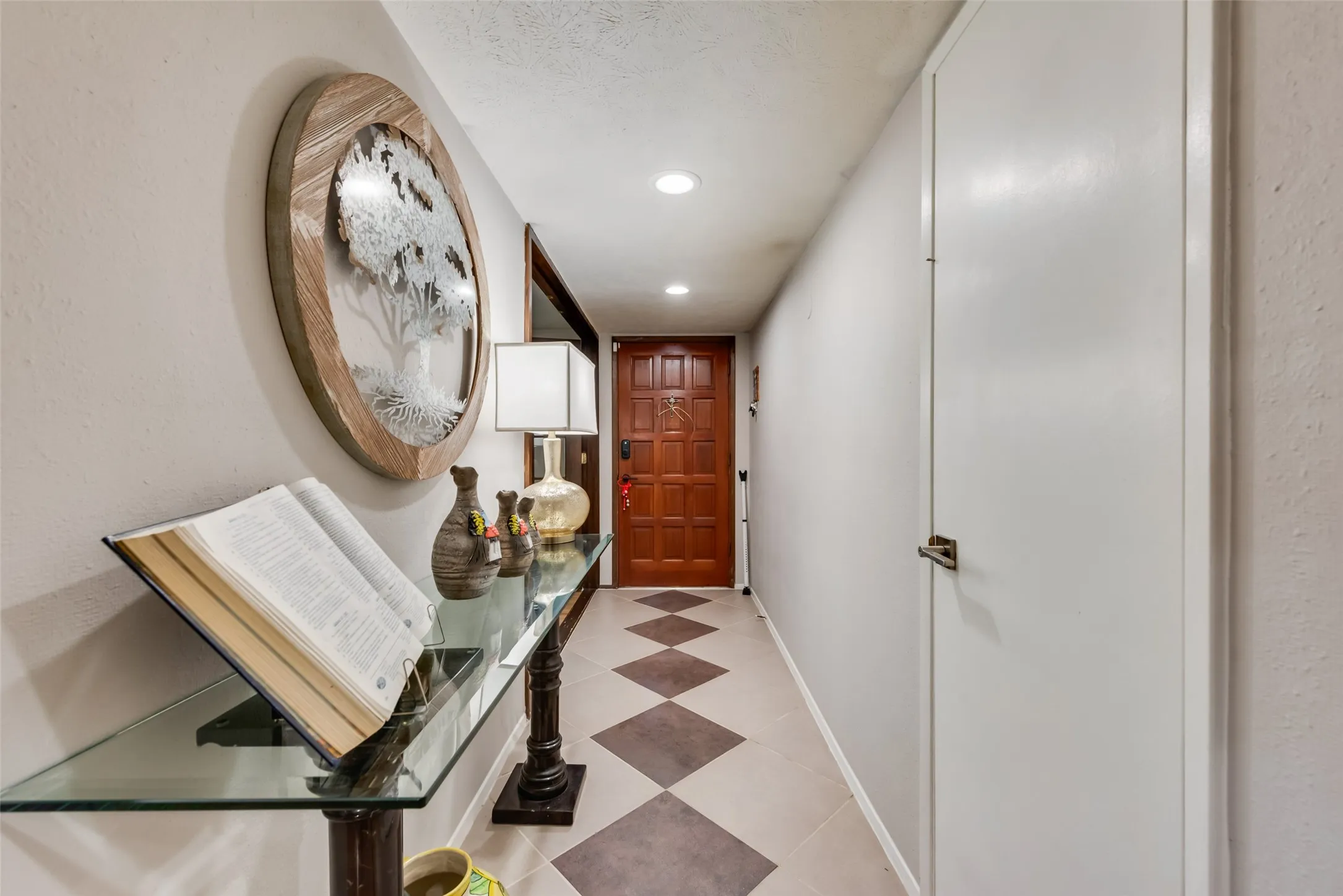 Corridor featuring baseboards and recessed lighting