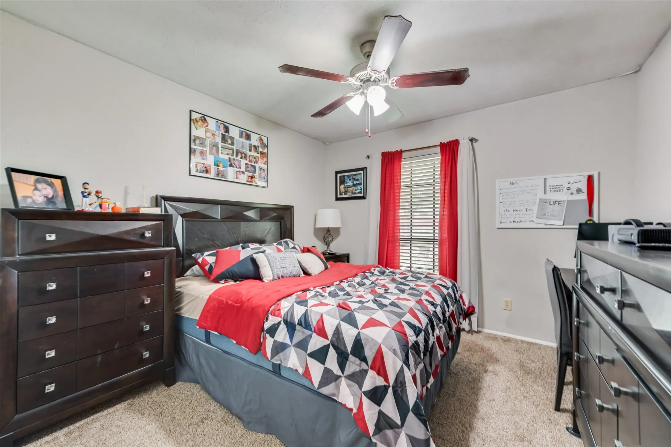 Bedroom featuring light carpet and a ceiling fan