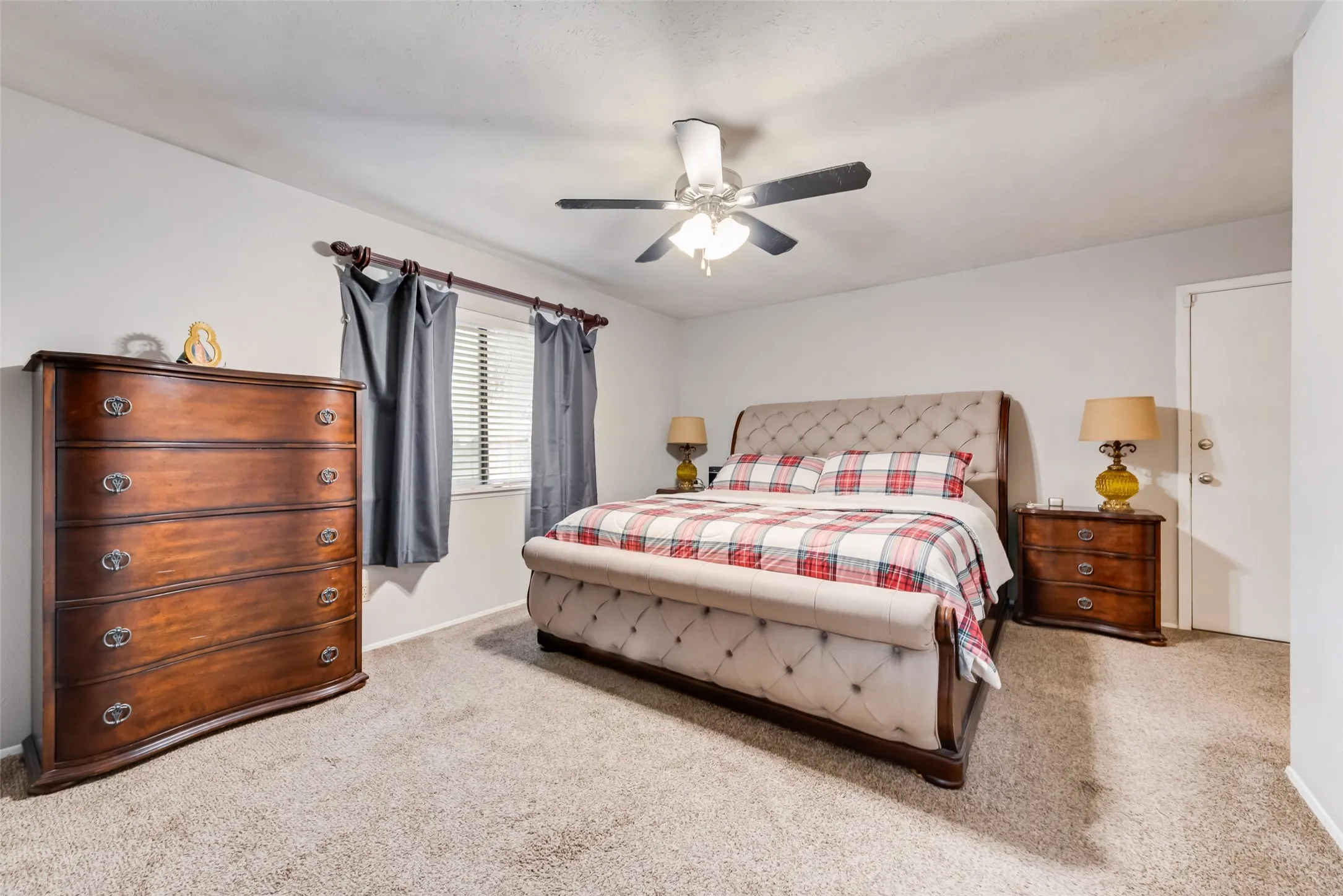 Bedroom with light carpet and ceiling fan