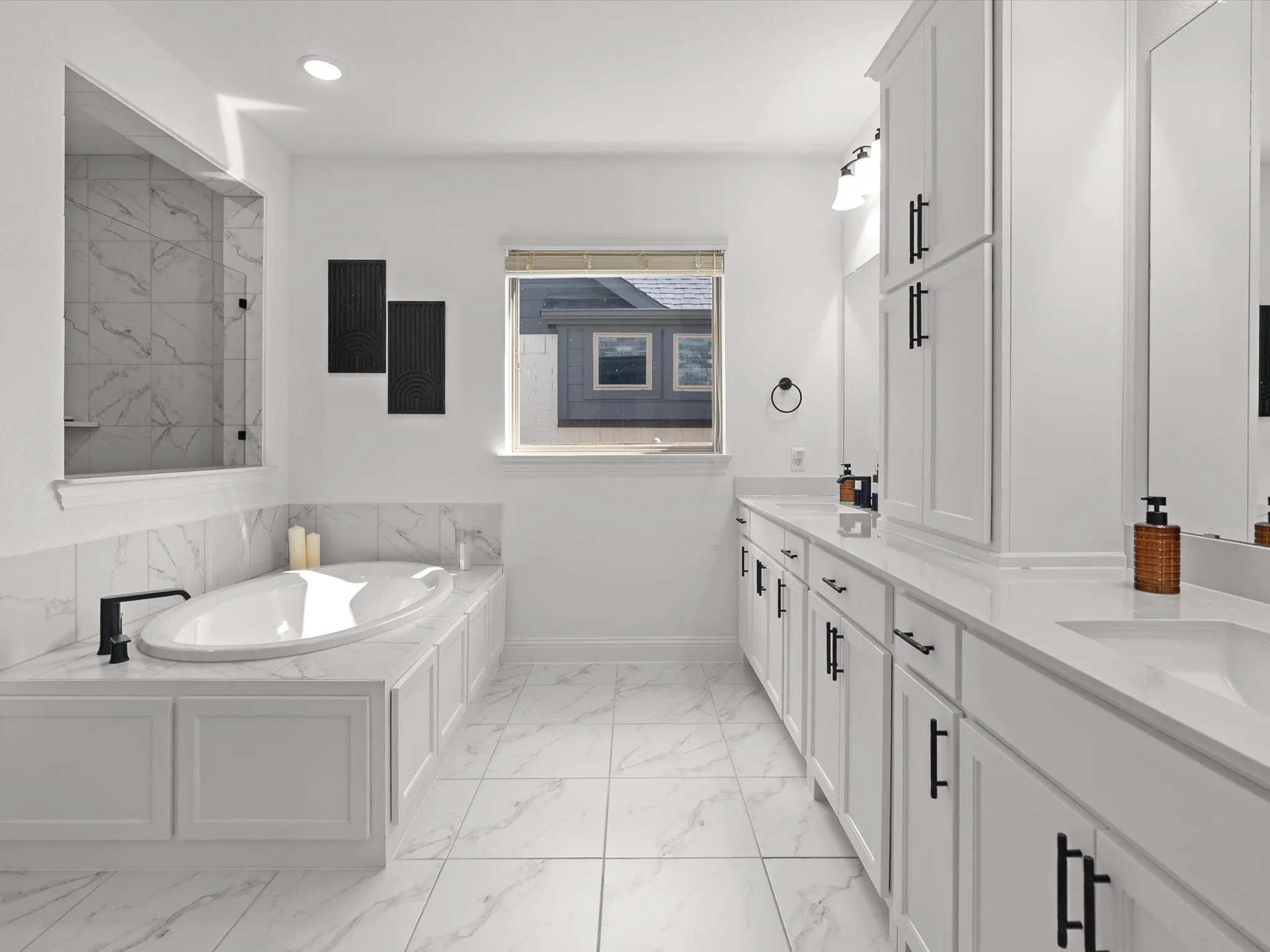 Soaking tub with black fixtures, walk-in shower with tile surround, dual vanity with white cabinetry, white countertops, and white tile flooring