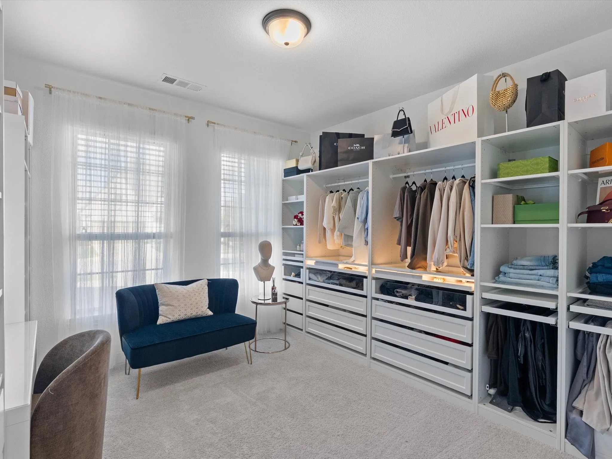 Custom closet system with integrated shelving, hanging rods, and drawer storage