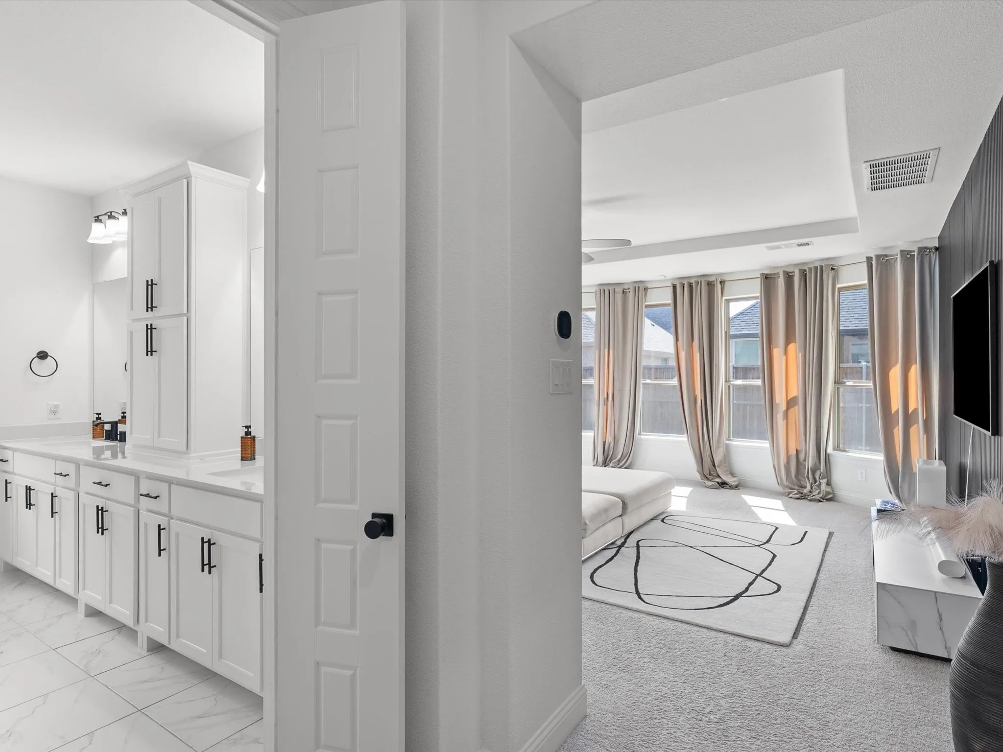 Dual vanity with white cabinetry and black hardware