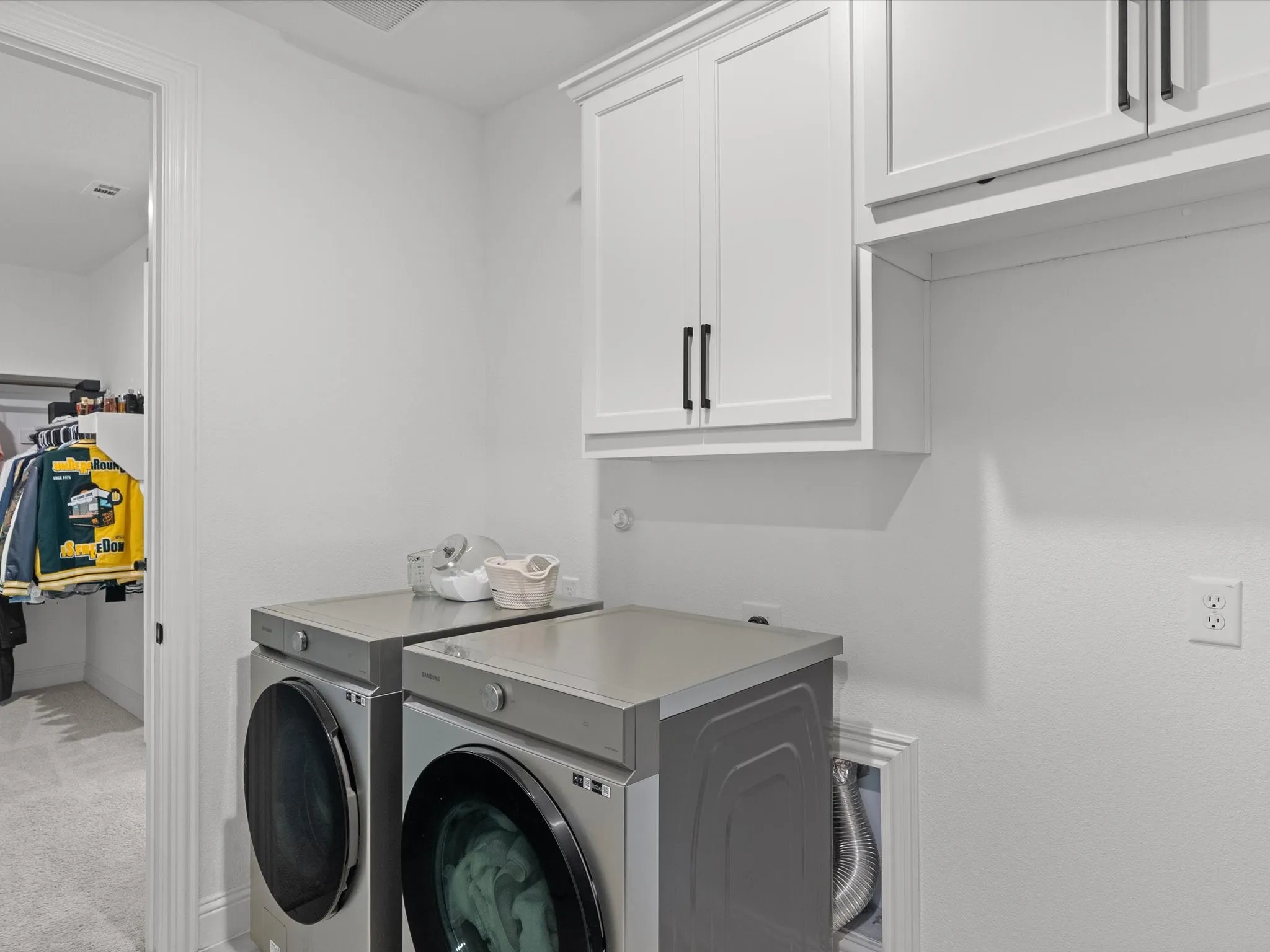 White shaker-style cabinetry with black hardware