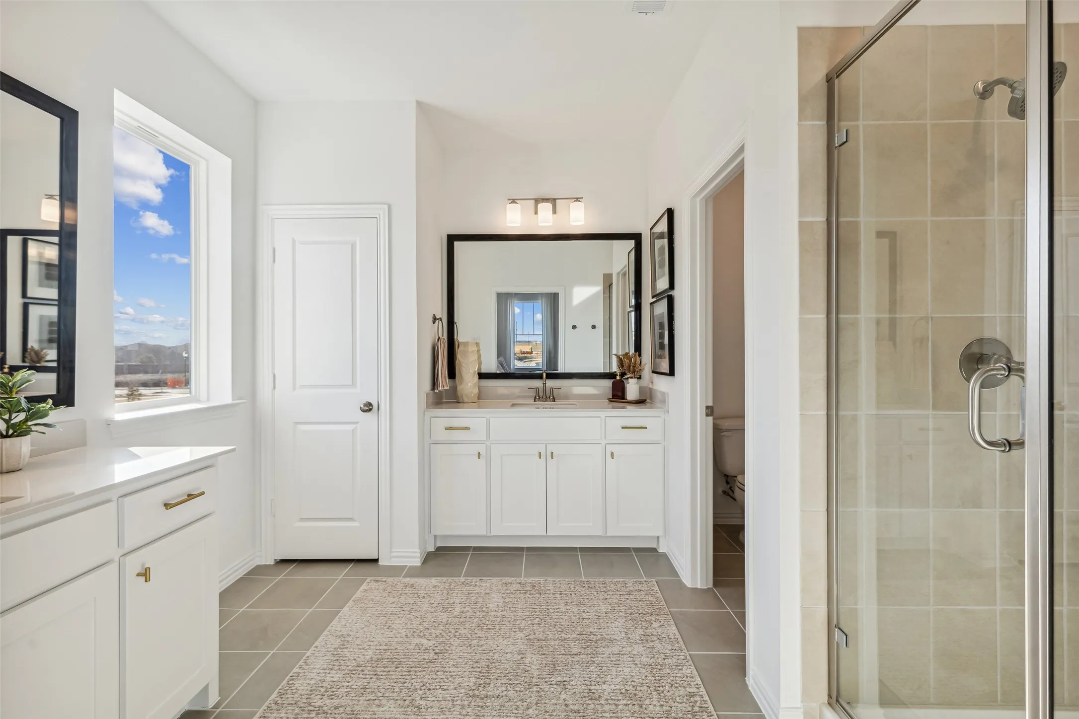 Featuring his and her vanities, this lovely owner's suite has ample room for two!