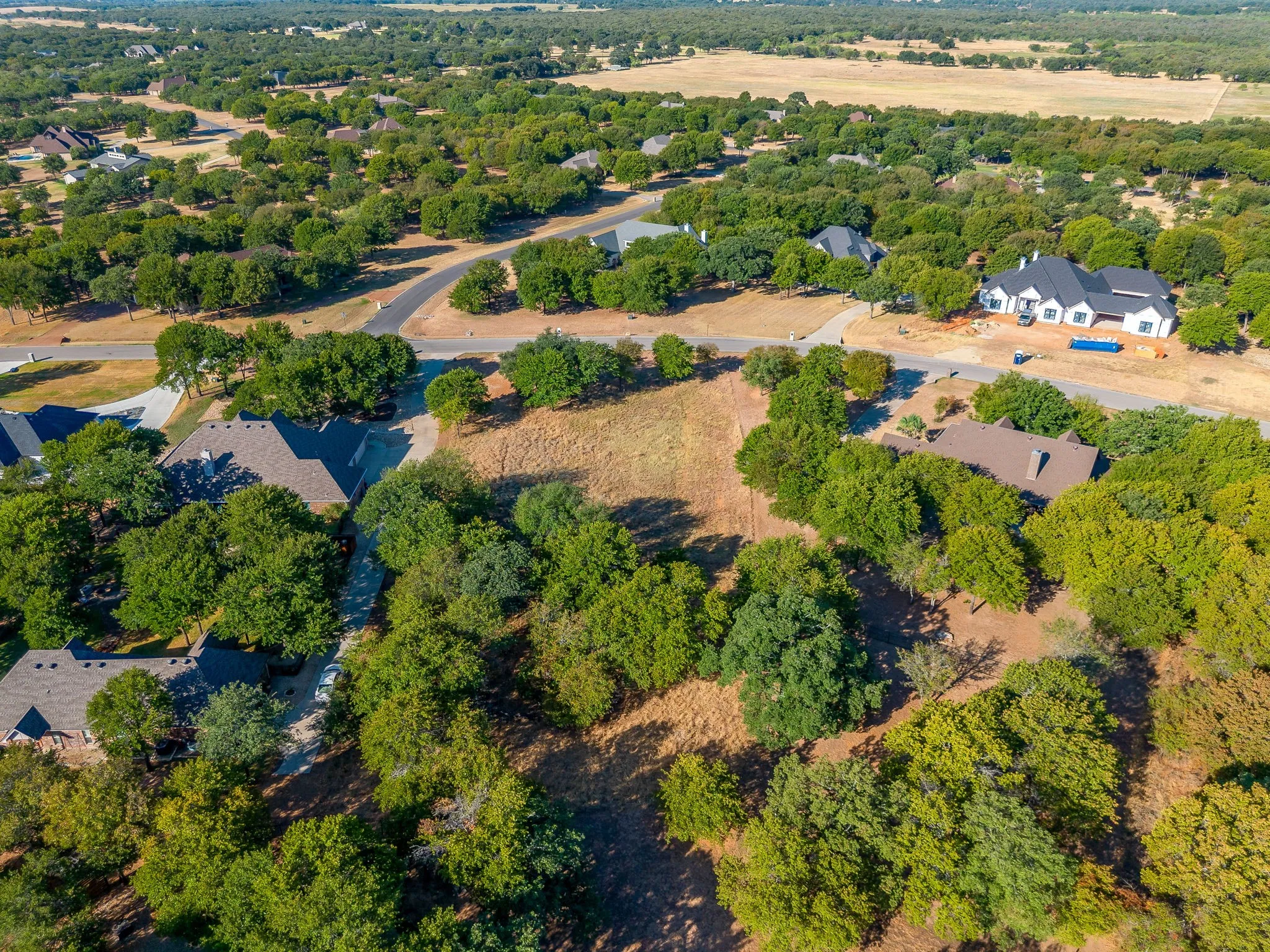 Expansive lot featuring mature trees and a cleared building site