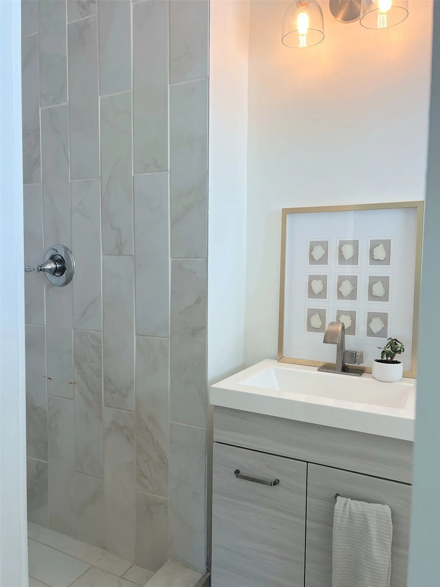 Tiled shower surround with a chrome shower control