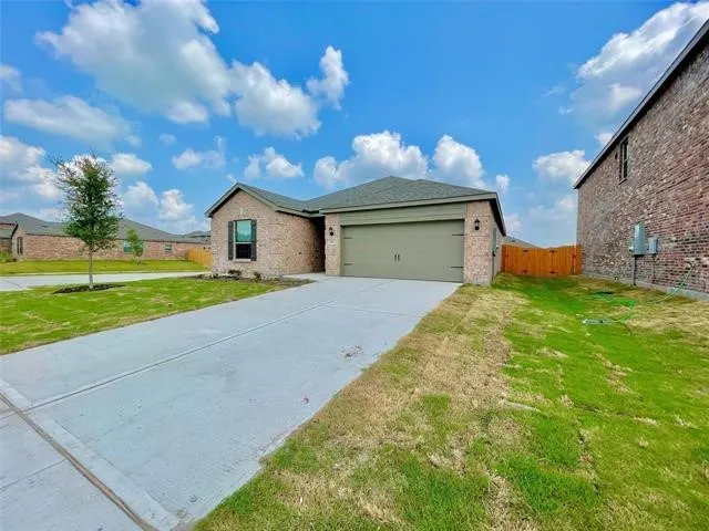 Brick exterior with a single-car garage, concrete driveway, and side yard access