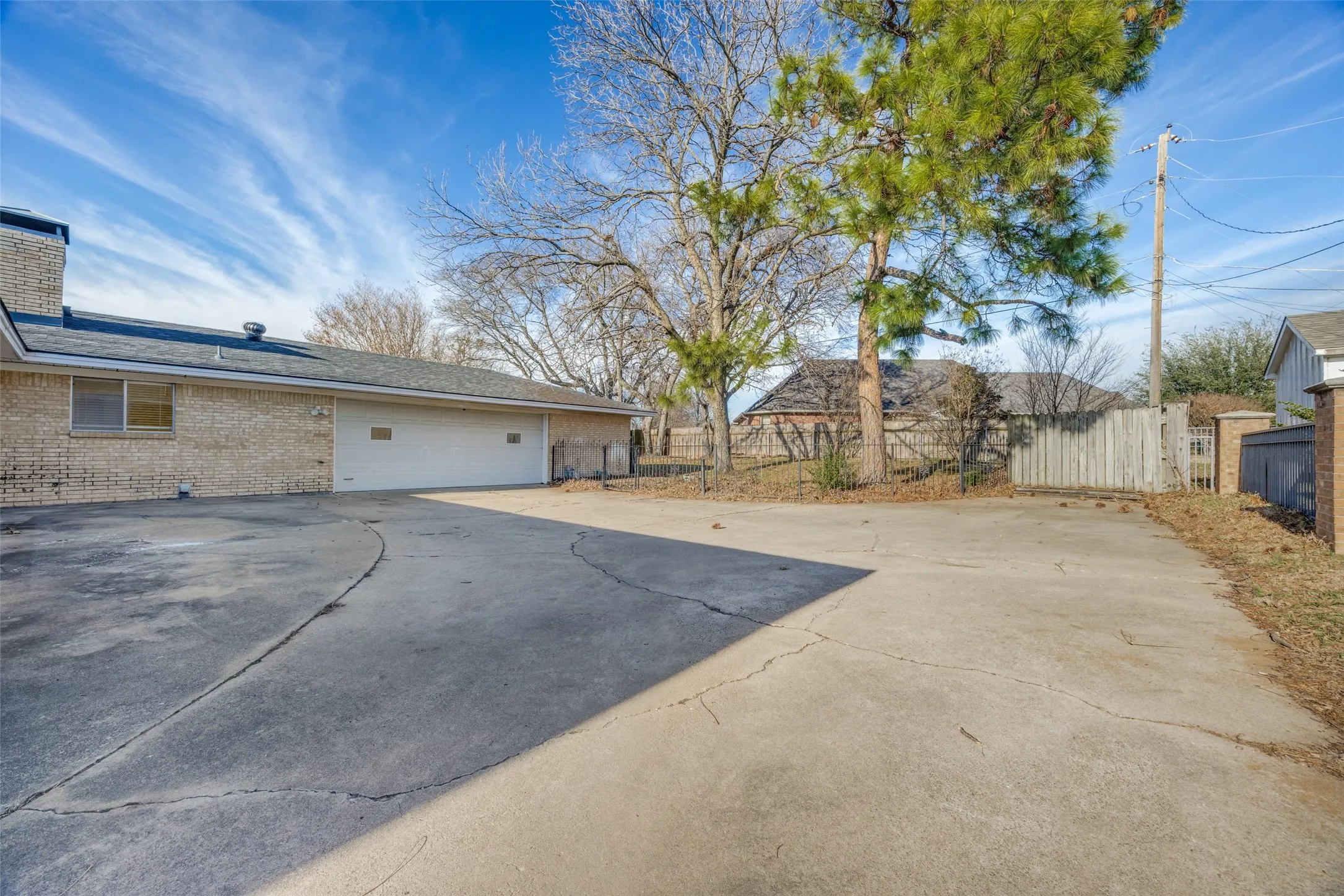 View at the end of the long driveway that leads to the 3 car garage - there is only a double door entry, making the extra space ideal for a workshop.