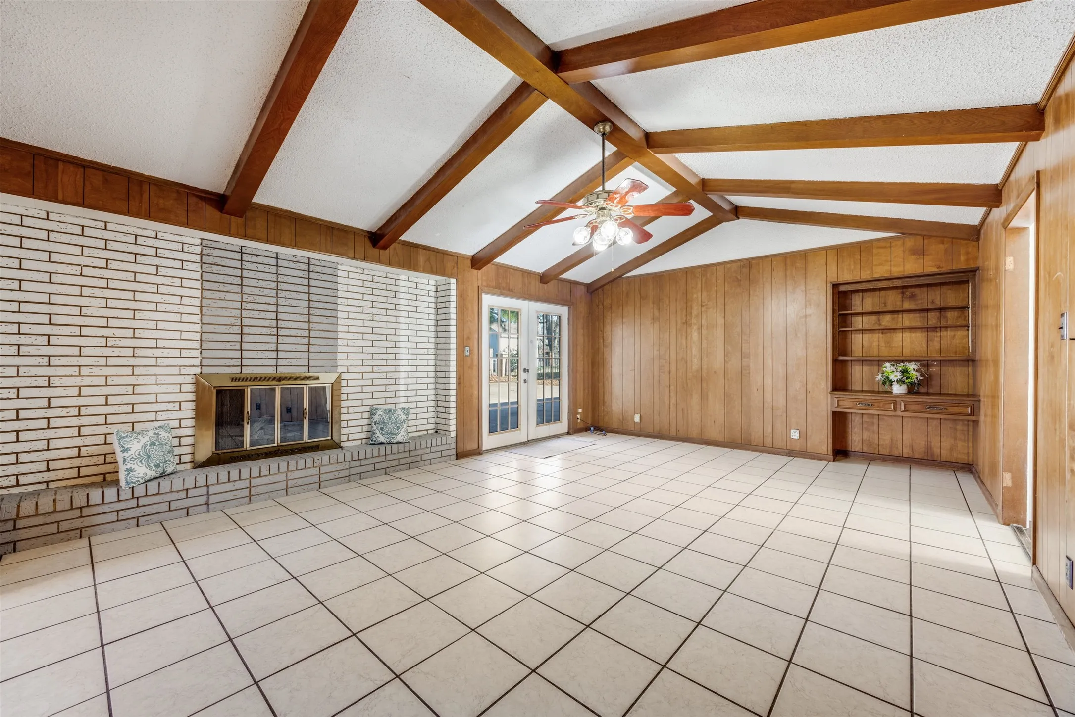 Beautiful and spacious family room with tile floor & beamed vaulted ceiling.