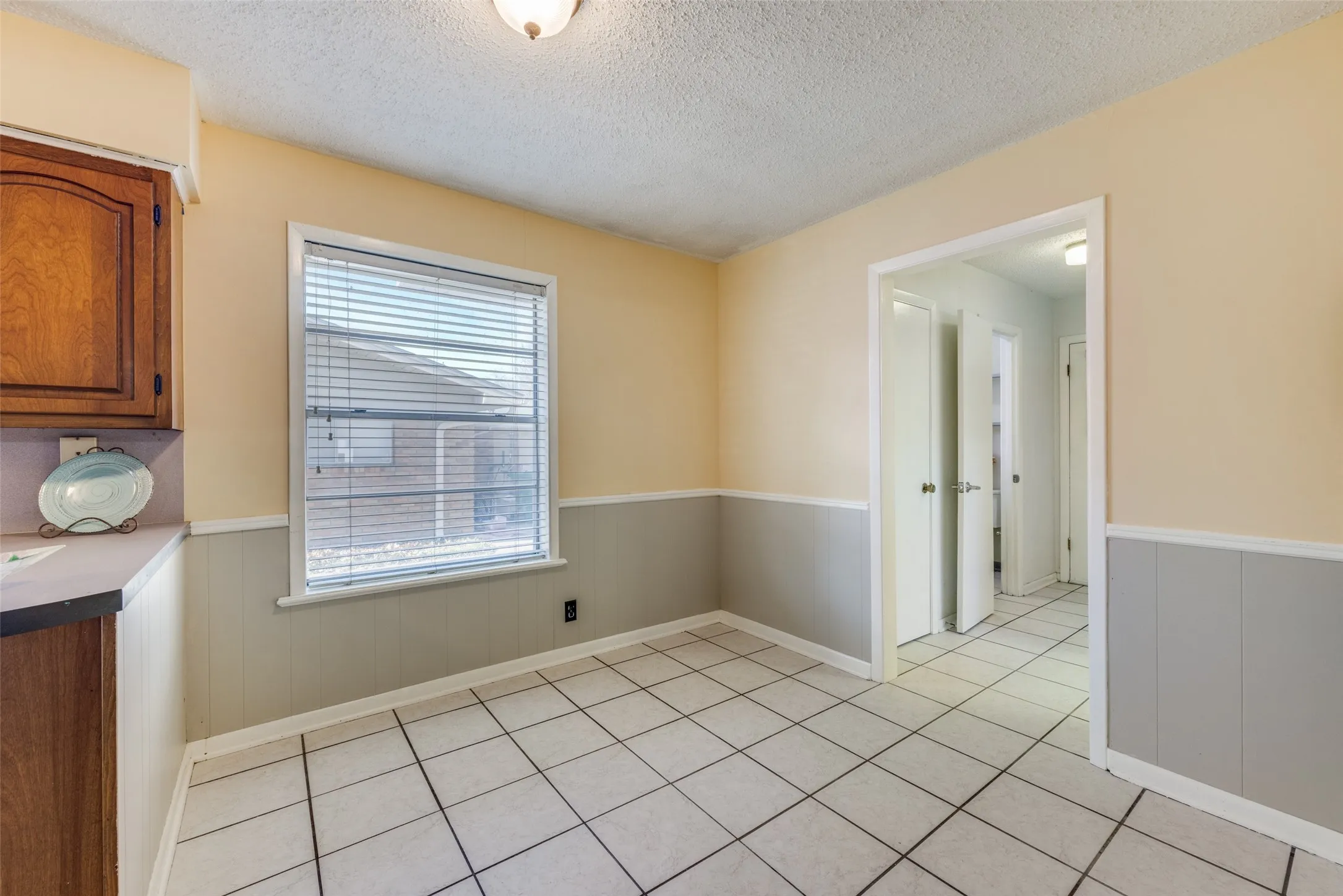 Charming breakfast room leads to convenient guest bath, utility room, and garage.