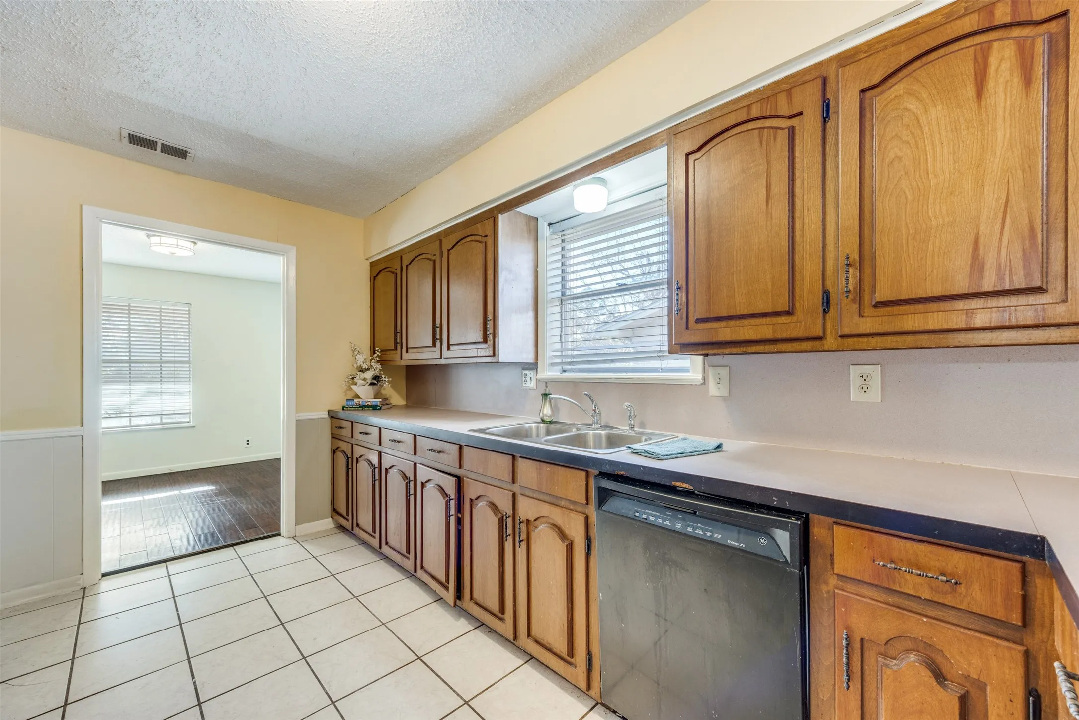 Alternate view of kitchen and opening to formal dining.